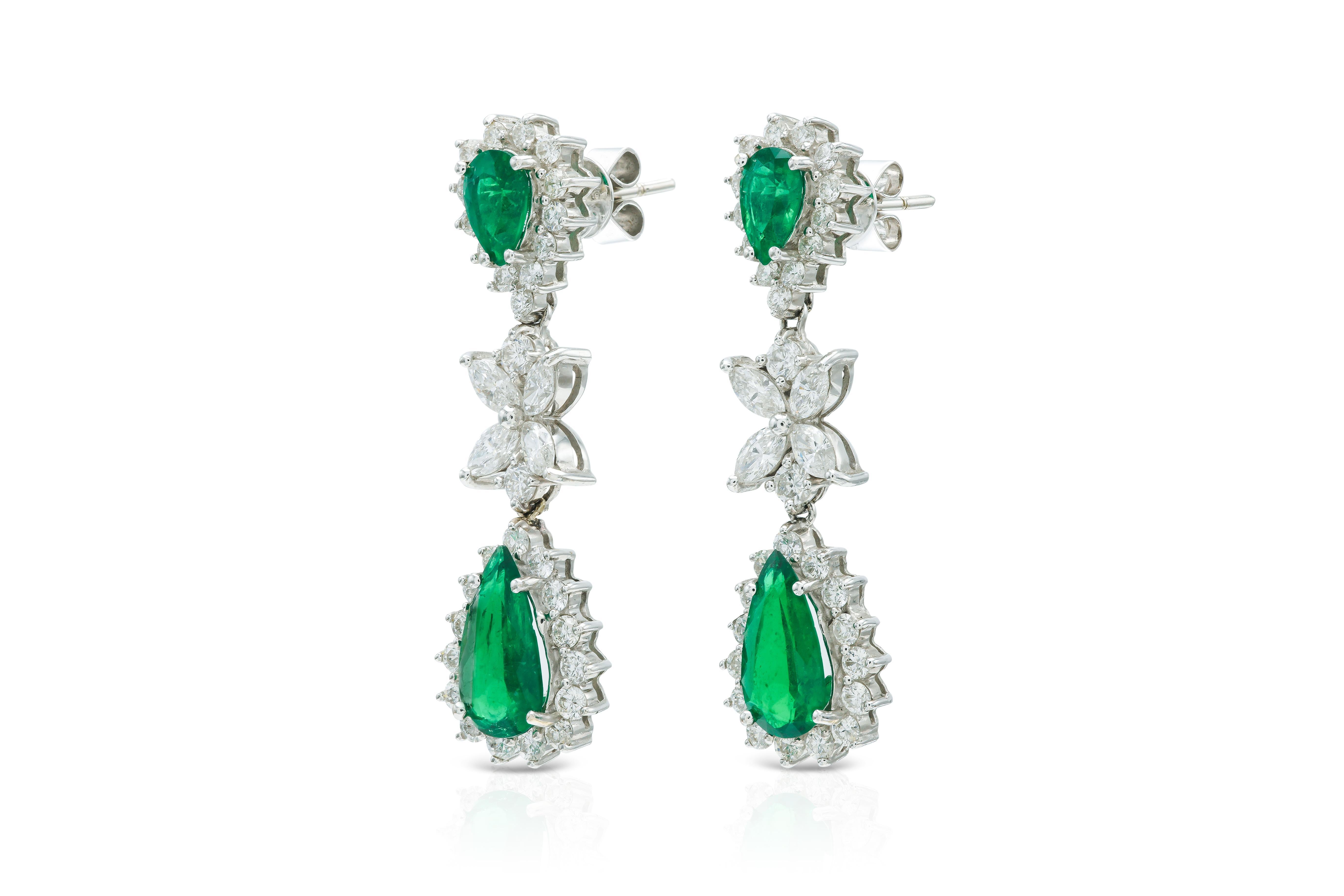 Finely crafted in 18k white gold with 4 Pear-Shaped Emeralds weighing a total of approximately 3.50 carats, Round Brilliant cut Diamonds weighing a total of approximately 2.06 carats, and Marquise cut Diamonds weighing a total of approximately 0.90
