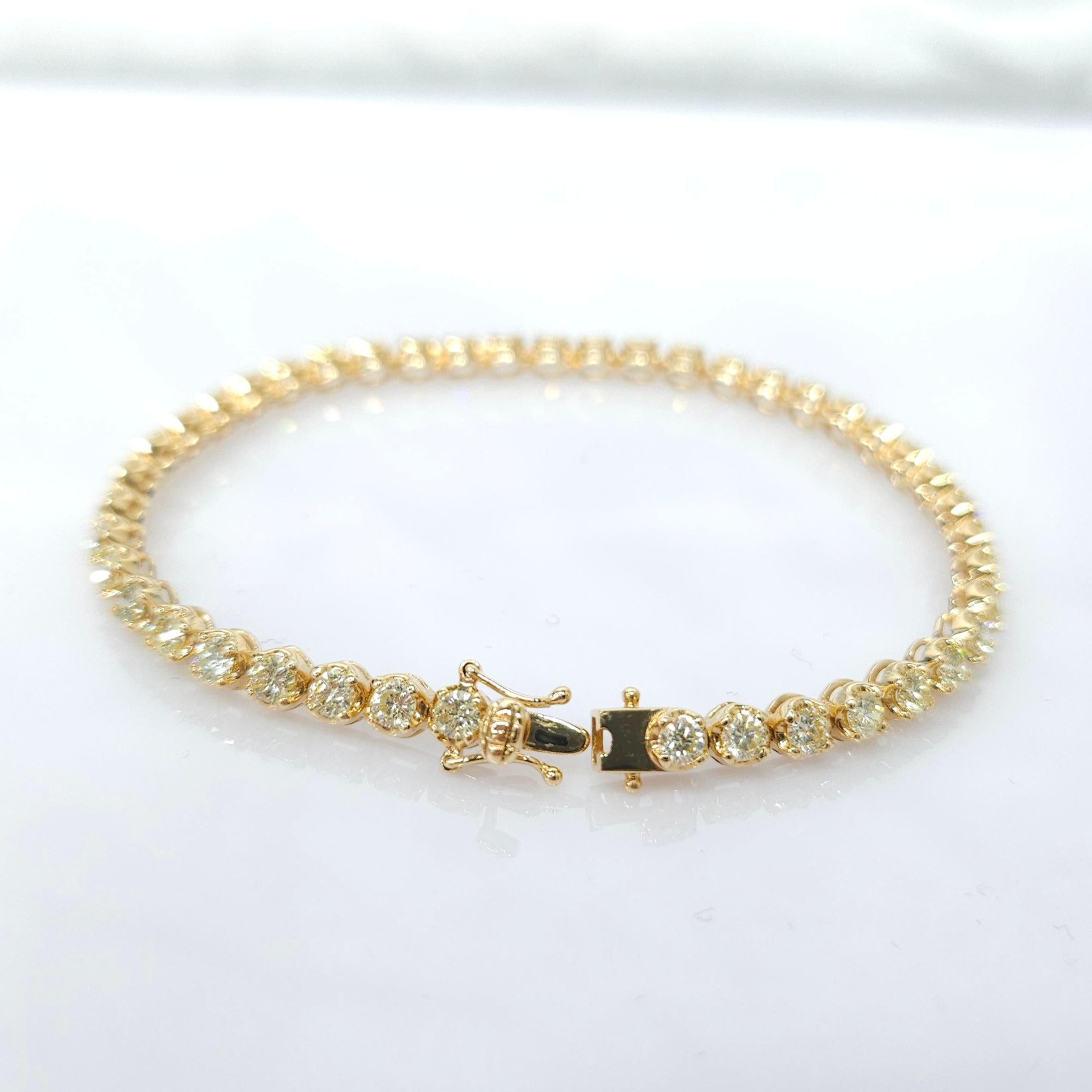 Elevate your jewelry collection with the exquisite beauty of this 3.50 Carat Total Round Diamond Tennis Bracelet in 18K Yellow Gold. This stunning piece is designed to captivate and dazzle with its innovative new design and impeccable