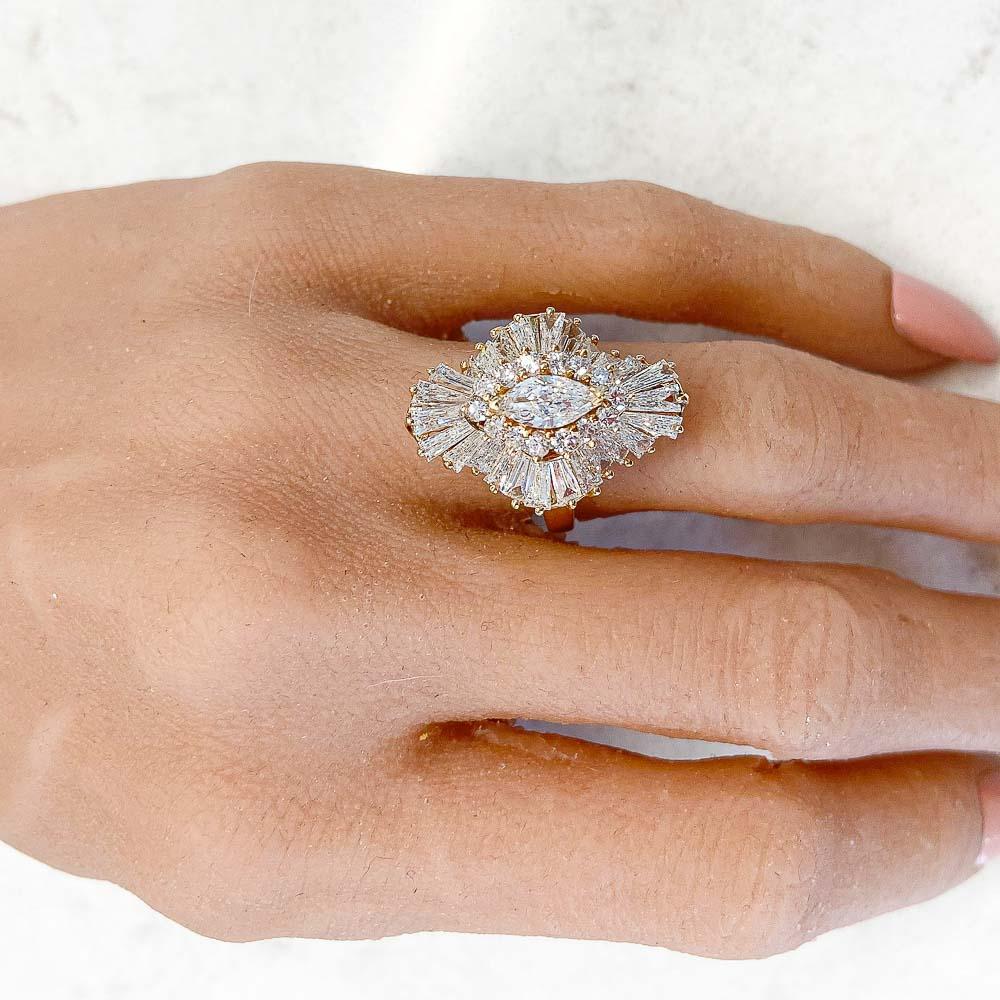 This is the perfect example of a fancy ballerina ring! The 3.50 carats of natural diamonds are a marquise cut center, surrounded by round and baguette diamonds flowing with grace. Crafted in 14K yellow gold, this ring is stunning.