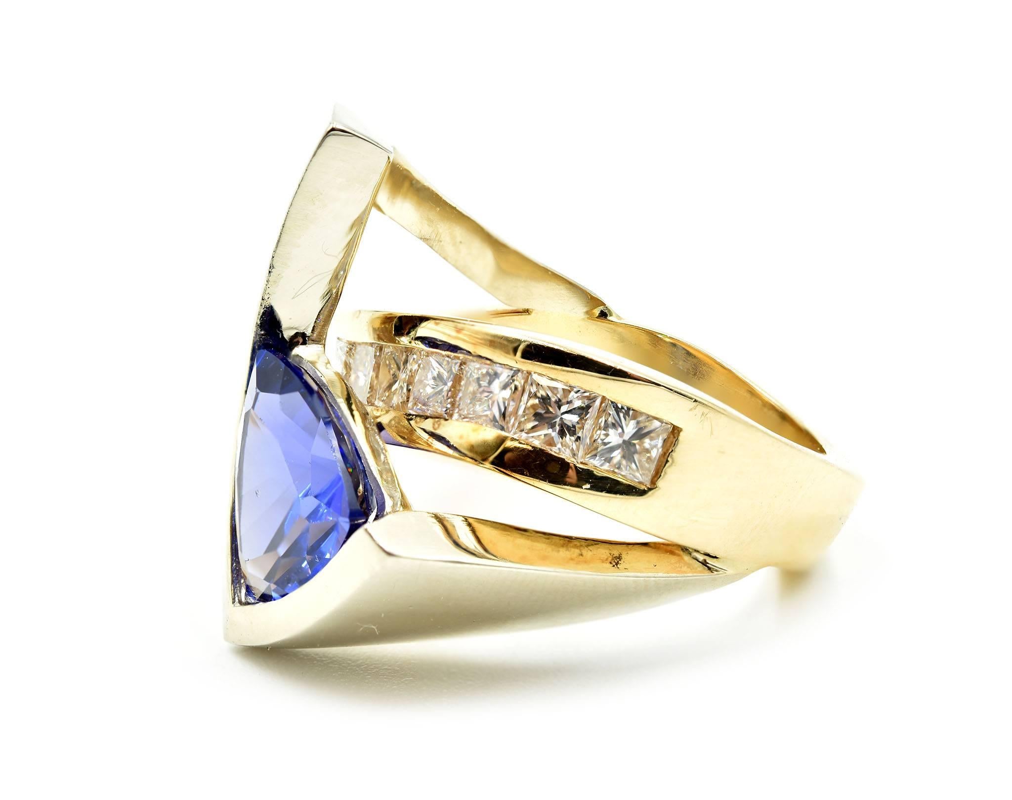 Designer: custom design
Material: 14k Yellow Gold and White Gold
Tanzanite: one trillion cut vivid purple tanzanite 3.50 carat gemstone with fine gem quality color
Diamonds: nine princess cuts = 1.30 carat total weight
Color: G-H
Clarity: