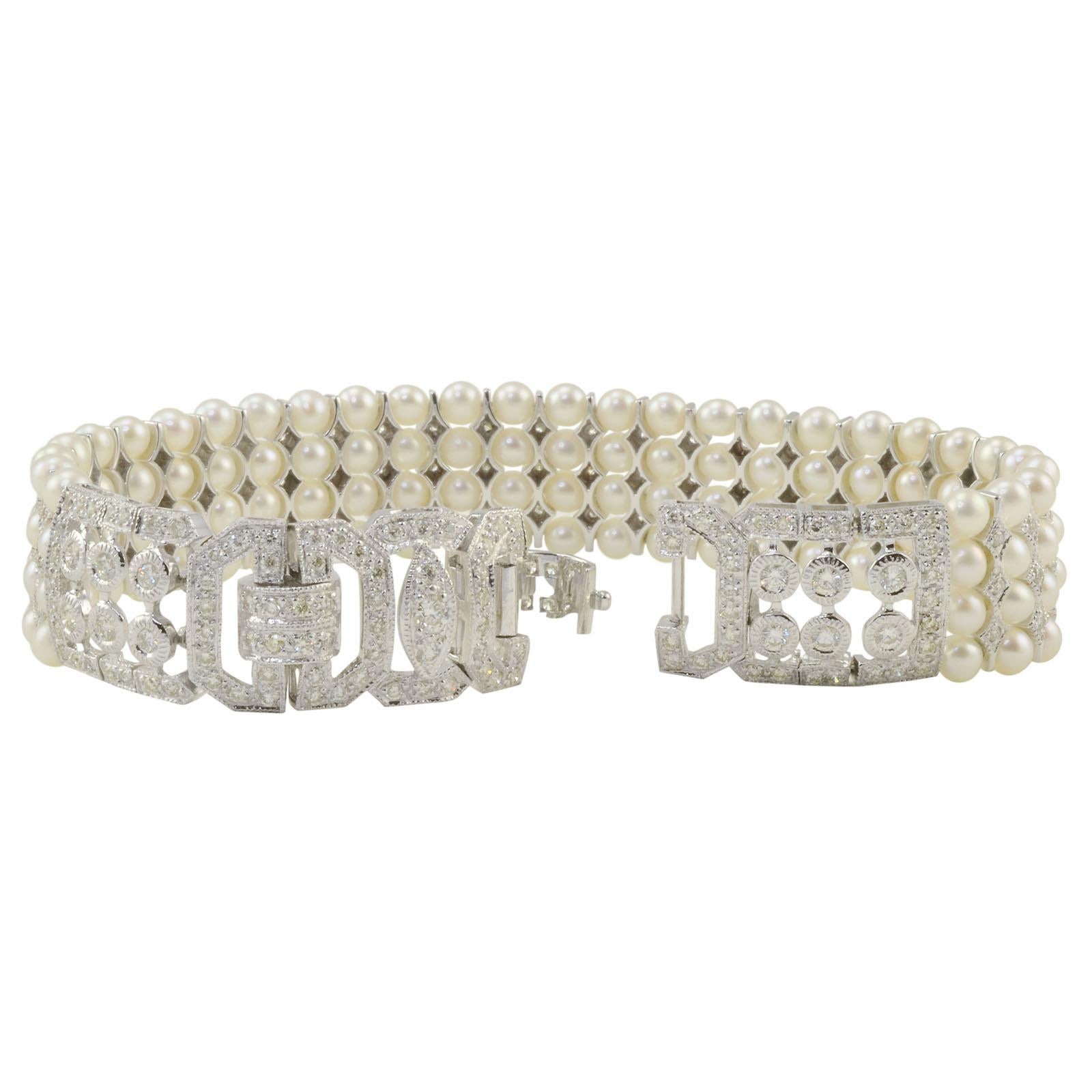 Estate 3.50 CTW diamond and four strand pearl bracelet. This 7 inch 18 karat white gold bracelet has round diamonds at approximately 3.50 carat total weight VS-SI clarity H-I color and four strands of natural Japanese pearls. This pearl and diamond