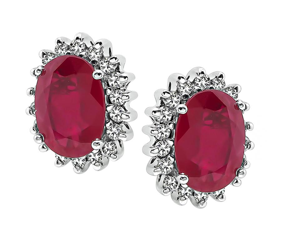 This is a charming pair of 14k white gold earrings. The earrings feature lovely oval cut Burmese rubies that weigh approximately 3.50ct. The rubies are accentuated by sparkling round cut diamonds that weigh approximately 0.70ct. The color of of