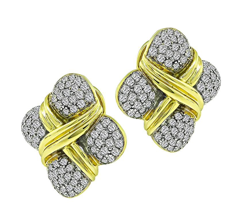 This is a magnificent pair of 18k yellow and white gold earrings. The earrings feature sparkling round cut diamonds that weigh approximately 3.50ct. The color of these diamonds is I with VS clarity. The earrings measure 27.5mm by 27.5mm and weigh
