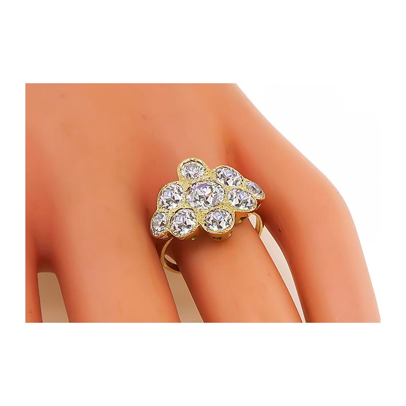 This is a charming 14k yellow gold ring. The ring is centered with a sparkling old mine cut diamond that weighs approximately 1.00ct. The color of the diamond is G-H with VS clarity. The center diamond is accentuated by dazzling old mine cut