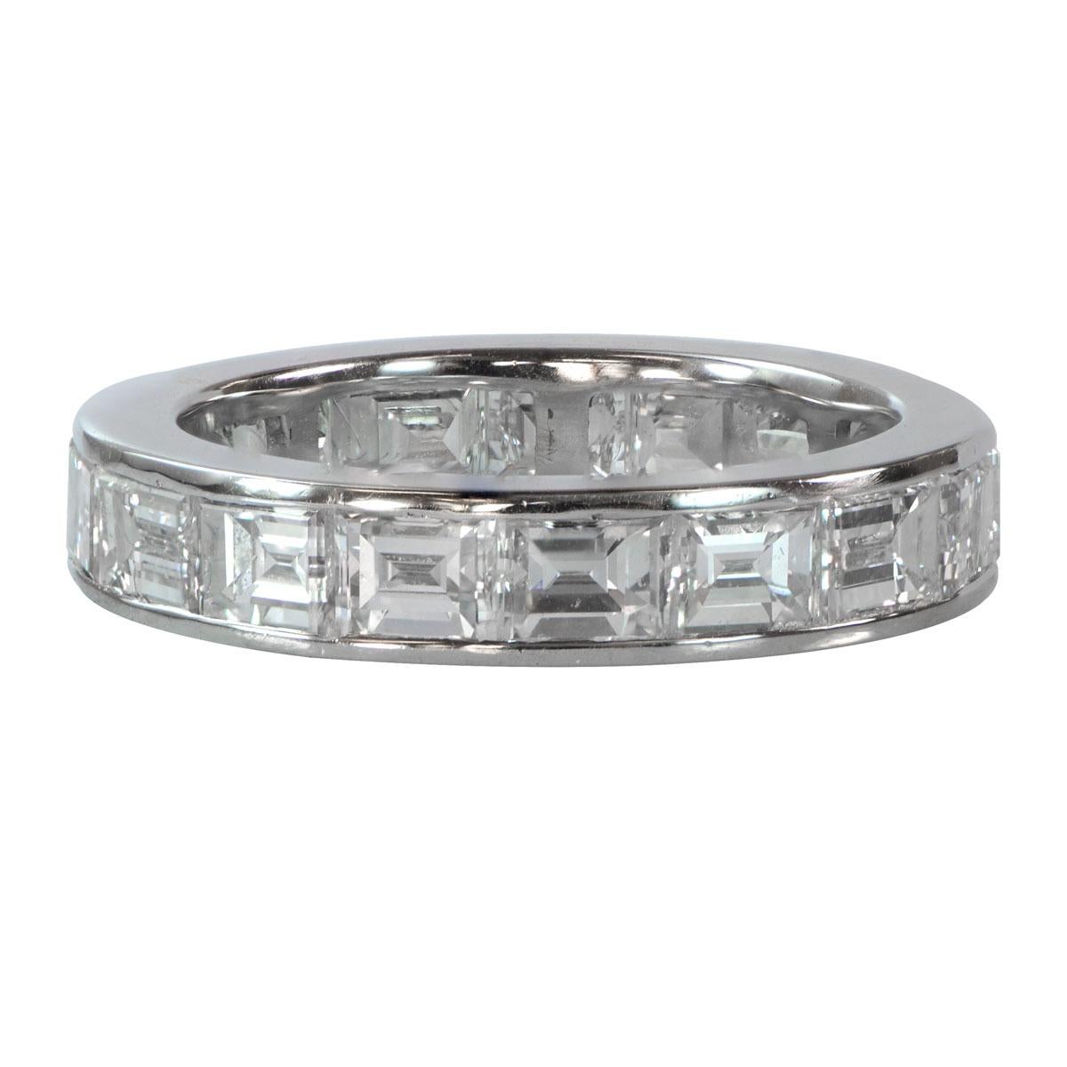 A breathtaking wedding band adorned with emerald-cut diamonds, channel-set within a beautiful platinum eternity band. The band boasts a 4mm width, creating a timeless and elegant look. The approximate diamond weight is 3.5 carats, showcasing
