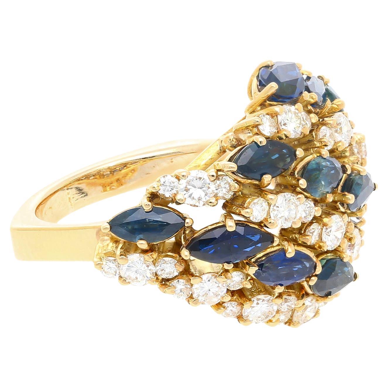3.50 carat marquise cut blue sapphire and 1 carat round cut diamond cluster ring in 18k yellow gold. Handmade with a gorgeous contrast design. 12 Marquise cut sapphires and 36 round cut diamonds. Each blue sapphire is securely 4-prong set with a