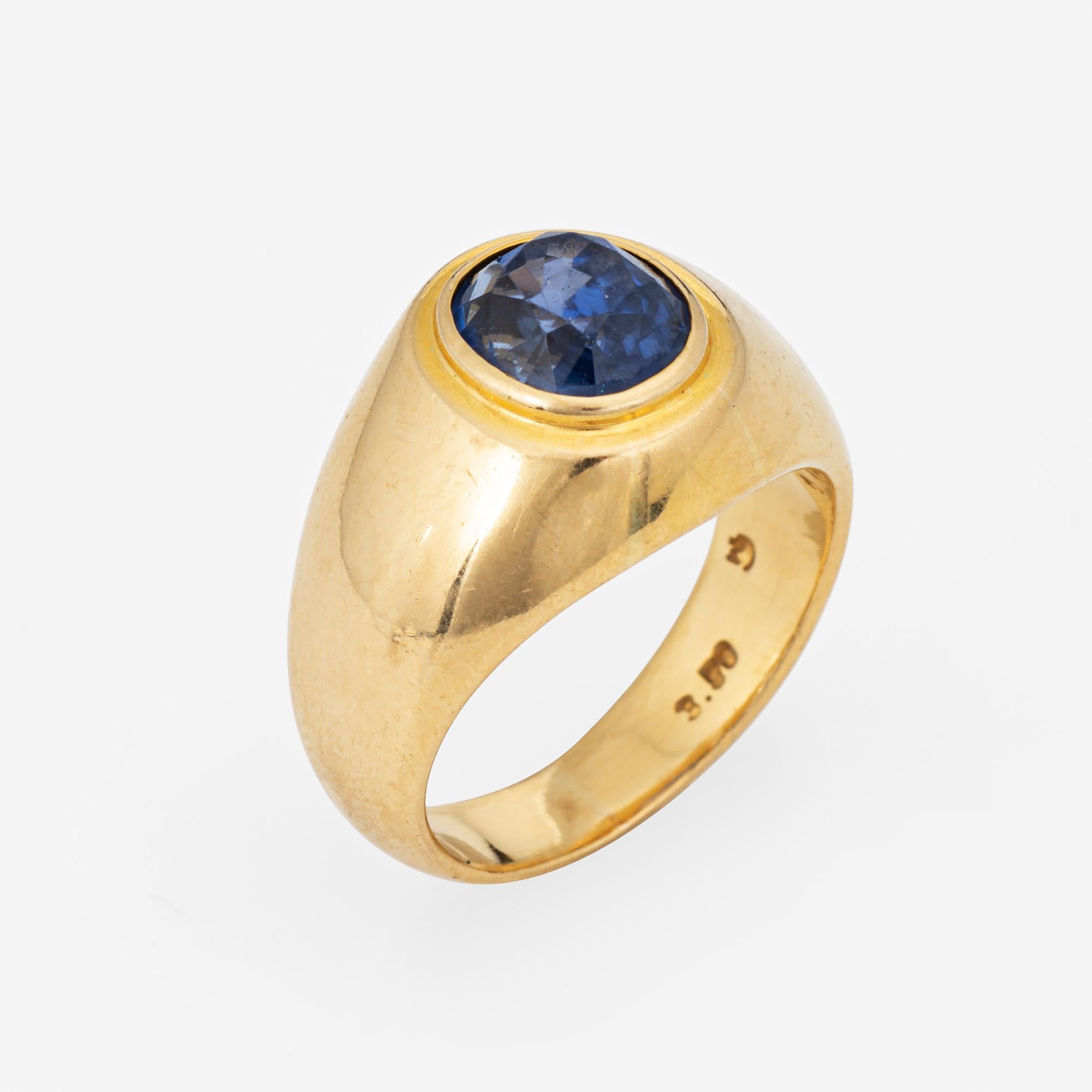 Stylish vintage natural Ceylon sapphire signet ring (circa 1990s) crafted in 18 karat yellow gold. 

Oval mixed cut natural sapphire measures 8.5mm x 7.8mm x 6.6mm (estimated at 3.50 carats). The sapphire is medium blue in color, lightly included,