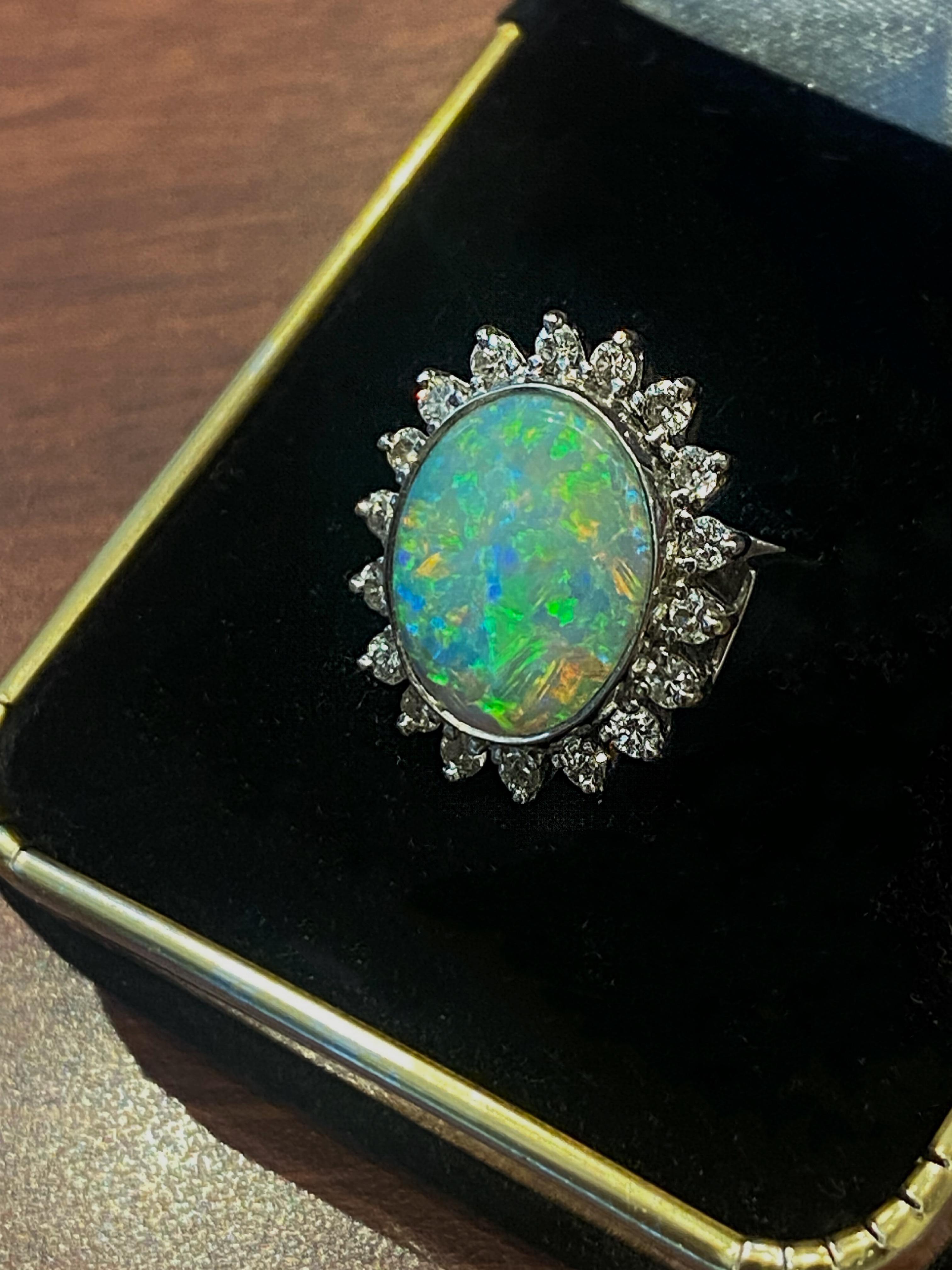 Performed in 18K White Gold, 
the ring is centrally set with 
a magnificent Australian Solid Opal 
of desirable oval shape, 
of impressive 3.50ct approx. 
(15 mm x 12 mm approx.), 
from Lightning Ridge, NSW

The gem is displaying the most unique &