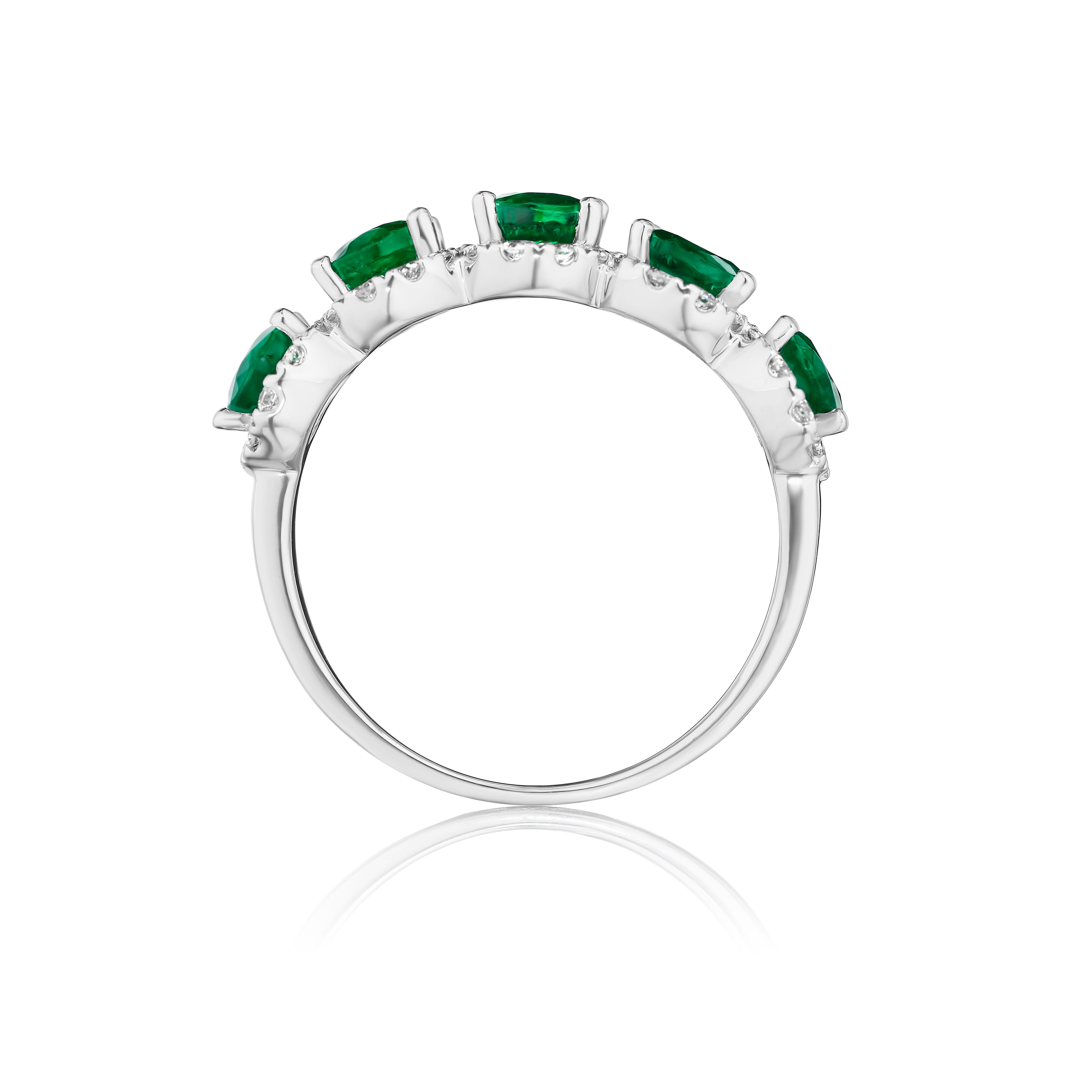 • Crafted in 14KT gold, this band is made with 5 oval cut green emeralds which are framed by a delicate halo comprised of round brilliant cut diamonds. The band has a combining total weight of approximately 3.55 carats. 

Worn beautifully on its