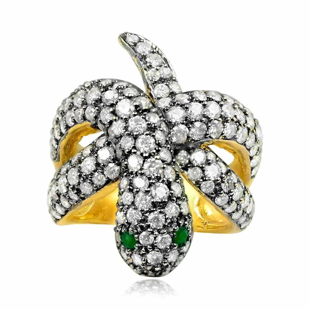 A striking snake ring exuding boldness, adorned with round brilliant-cut diamonds and featuring two mesmerizing emerald eyes on the snake's head. The total weight of the diamonds is approximately 3.5 carats, adding a touch of brilliance. The