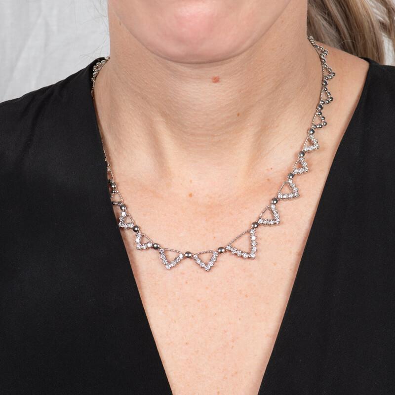 This unique necklace features geometric triangular designs with 3.50ct total weight in round diamonds set in 14 karat white gold. The length measures 16