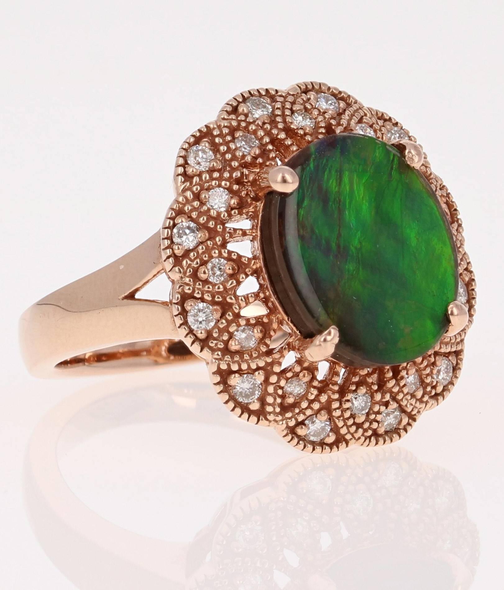 This unique ring has a 3.25 Carat Oval Cut Ammolite in the center of the ring.  Ammolite is an Opal-like organic gemstone that is primarily found in the eastern slopes of the North American Rocky Mountains. The Ammolite has hues of green and blue
