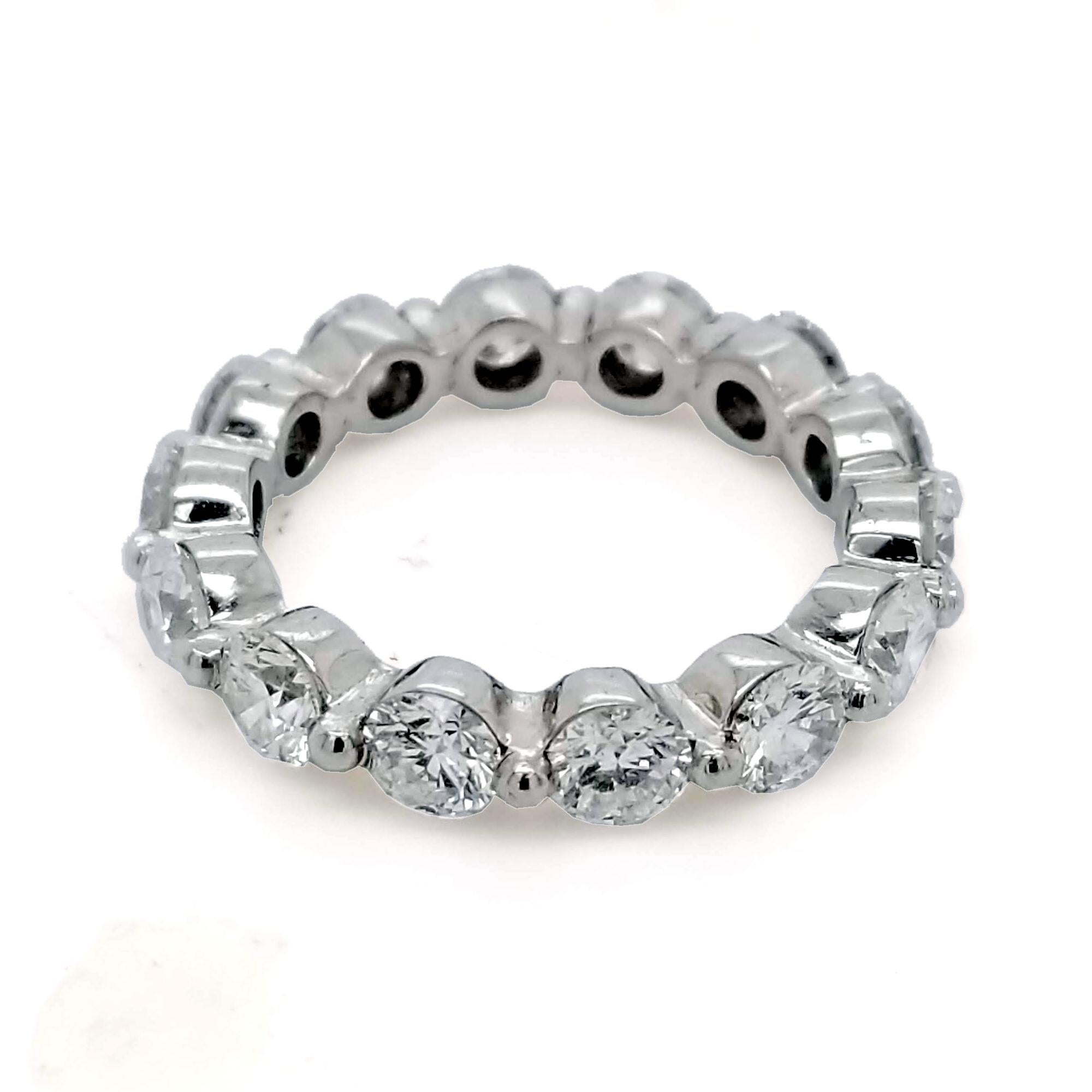 This beautiful Eternity Ring is made in Platinum with 14 perfectly matched 4mm Round Brilliant Diamonds Set in Shared Prong Mode In a platinum mounting.
Total Weight of diamonds: 3.51 Ct  SI/F-G
Total Weight of the Ring: 6.67 Gr Platinum
Ring Size:
