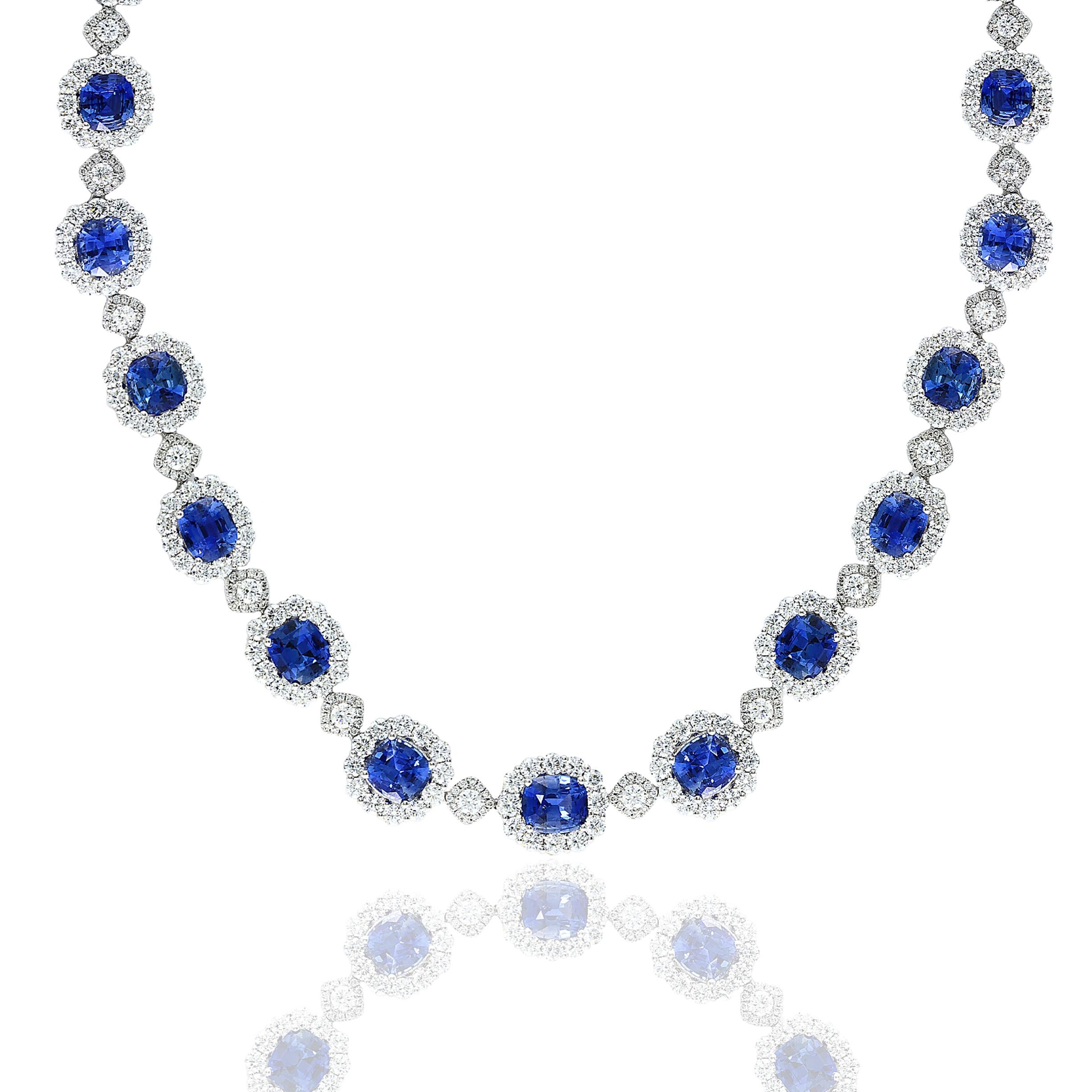 An important and very rare necklace showcasing vibrant and color-rich cushion-cut blue sapphires, set in a beautiful design. An intricately-designed necklace accented with brilliant cut diamonds in a 18K white gold mounting. 23 Blue Sapphires weigh