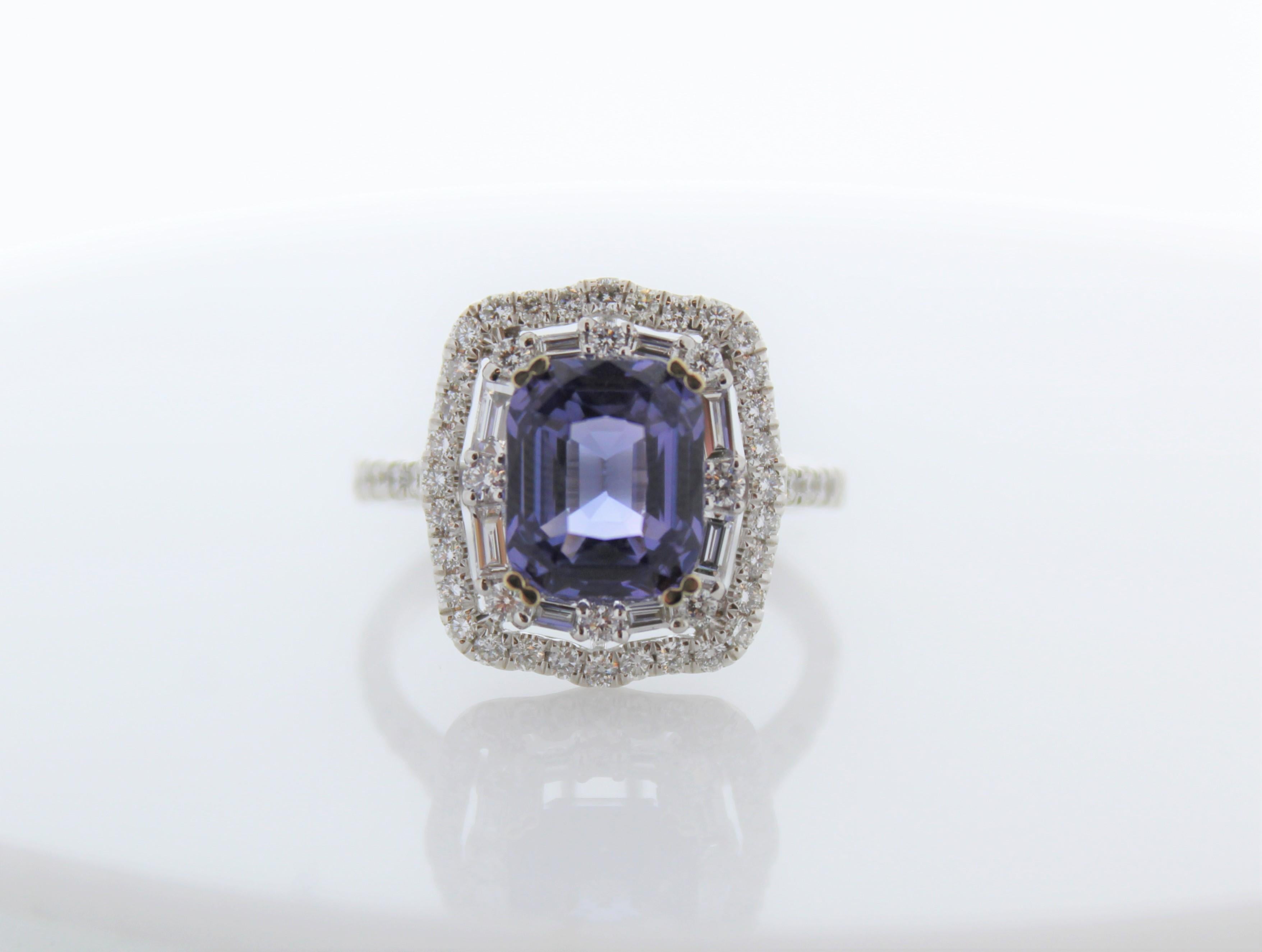 A ring fit for a queen! Your eye will be drawn magnetically to the 3.51 carats royal blue sapphire that is surrounded by a dazzling halo of round brilliant diamonds. The sapphire is from Sri Lanka. The color is royal blue; the luster & clarity are