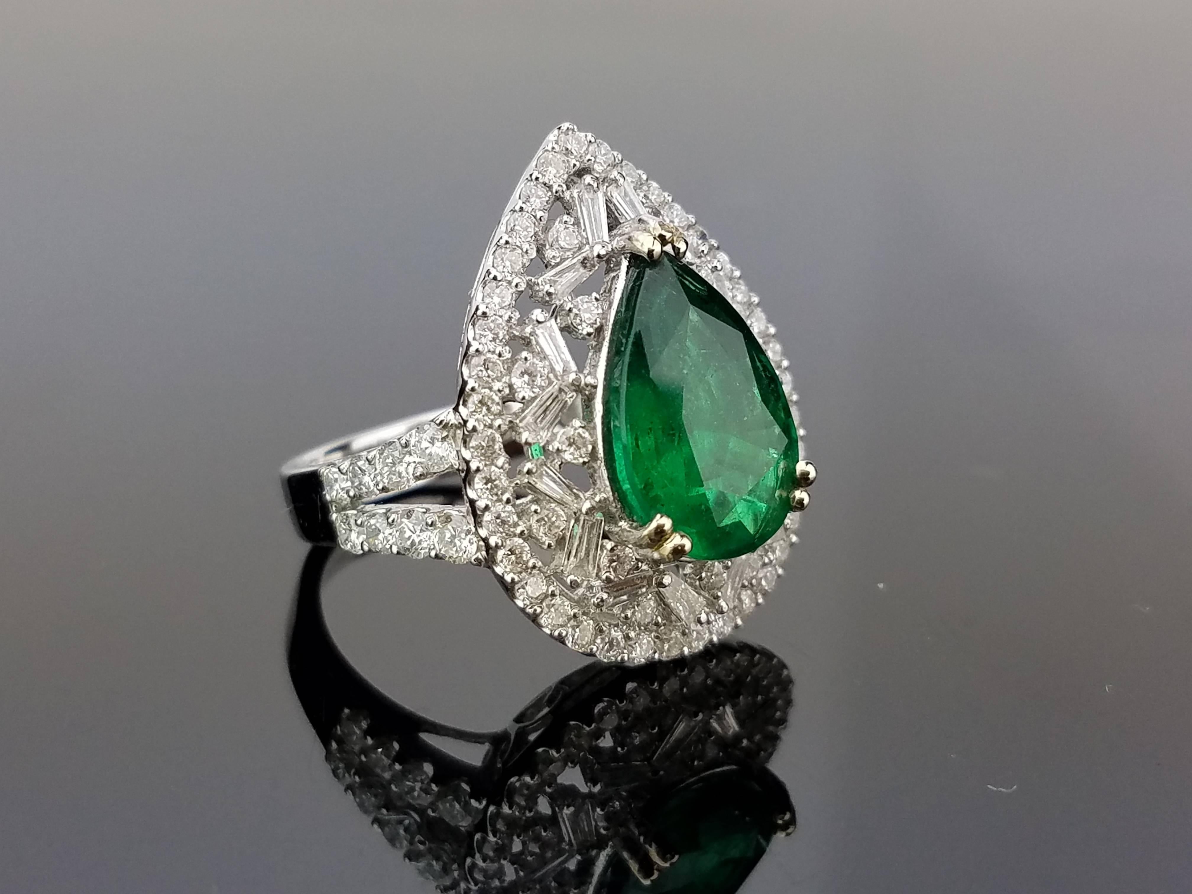 An elegant cocktail ring using a lustrous pear shape Emerald centre stone surrounded by baguette and brilliant cut white Diamonds, all set in 18K white gold. 

Stone Details: 
Stone: Emerald
Carat Weight: 3.52 Carats

Diamond Details: 
Total Carat