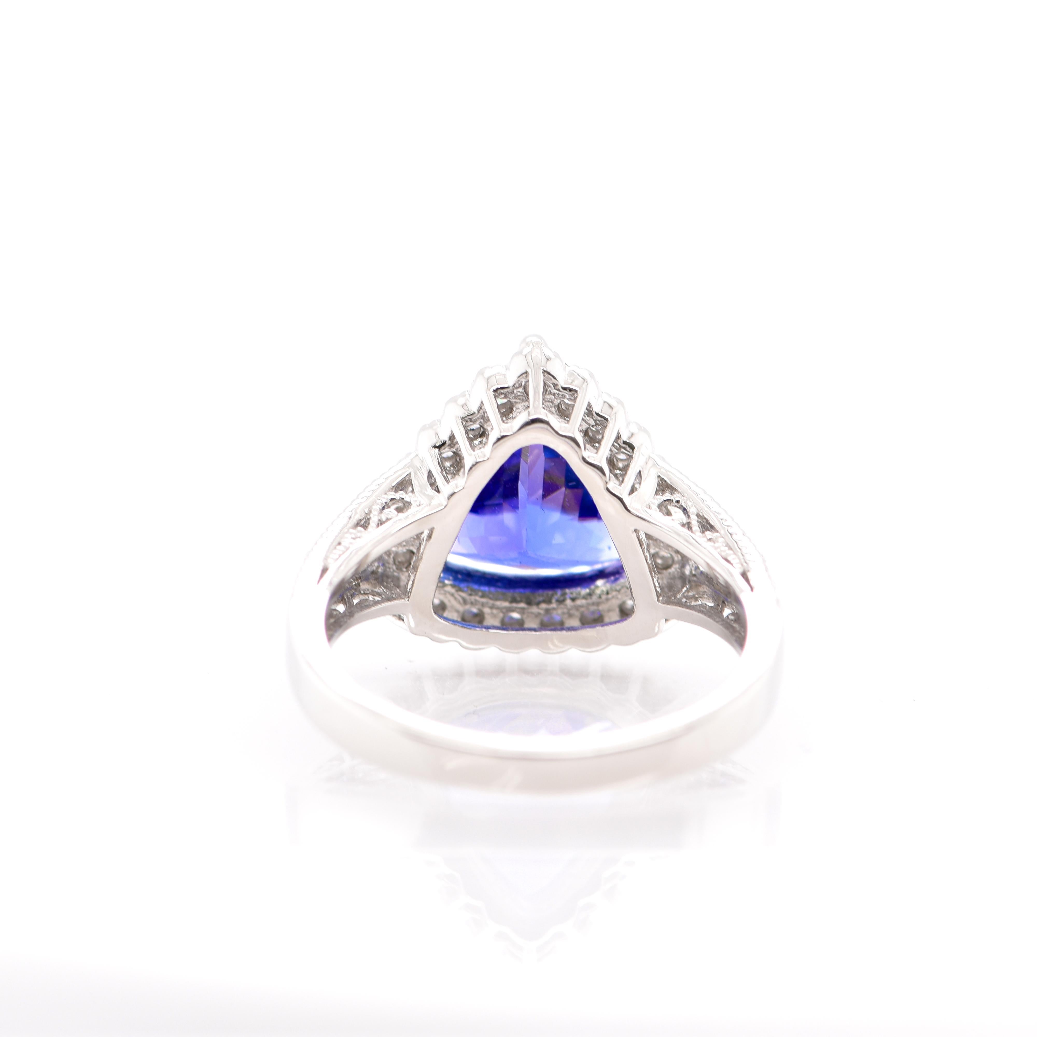 A beautiful Cocktail Ring featuring a 3.52 Carat Trillion Cut Tanzanite and 0.37 Carats of Diamond Accents set in Platinum. Tanzanite's name was given by Tiffany and Co after its only known source: Tanzania. Tanzanite displays beautiful pleochroic