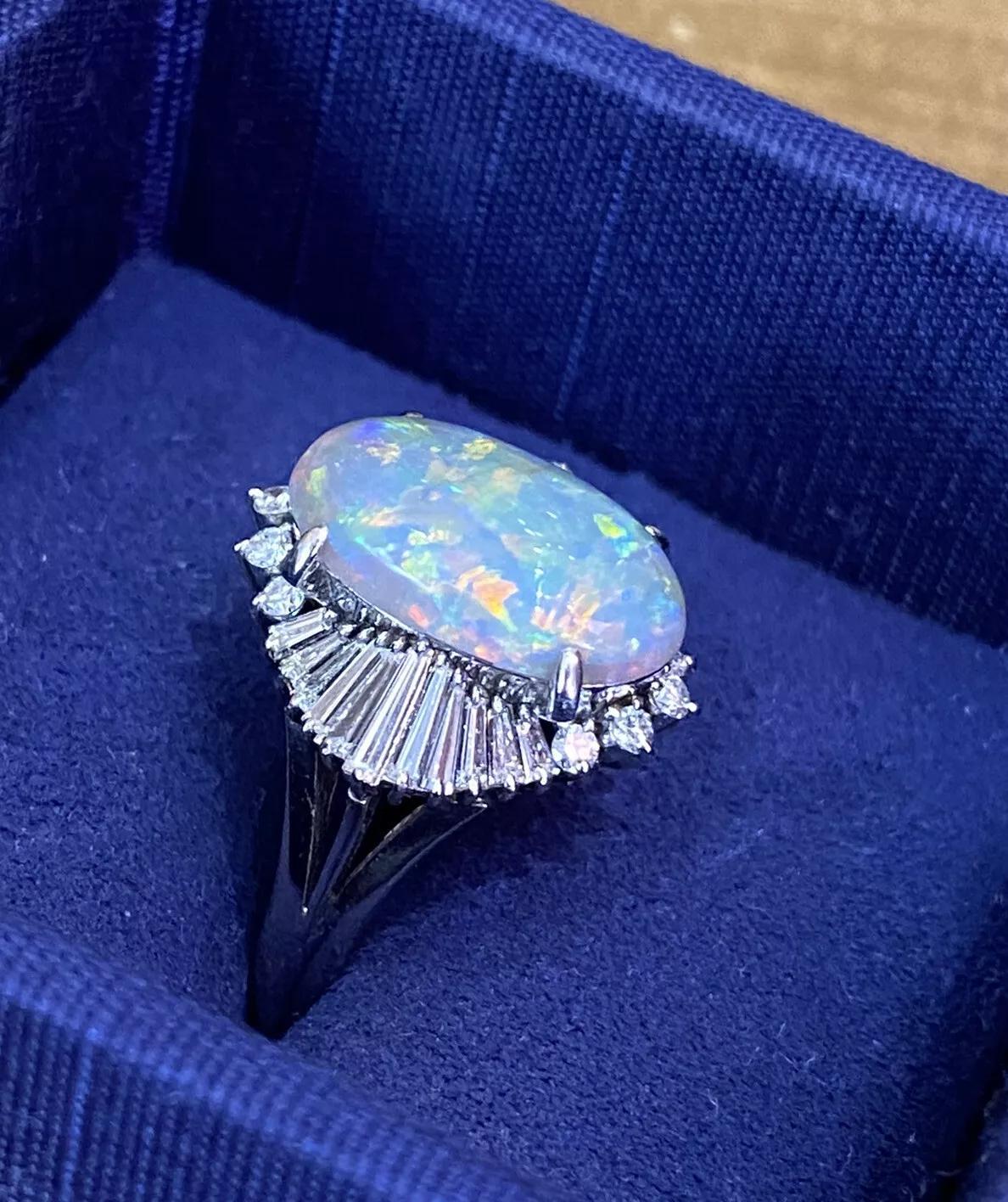 3.53 carat Black Opal and Diamond Ballerina Cocktail Ring in Platinum

Black Opal and Diamond Cocktail Ring features an Oval Shaped Black Opal weighing 3.53 carats with flashes of Blue, Green, Orange, and Yellow accented by 32 Baguettes and Round