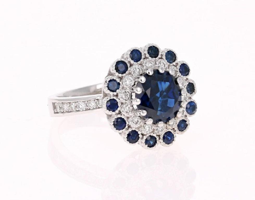 This ring has a Round Cut Blue Sapphire that weighs 2.49 carats which measures at 8.5 mm. The Sapphire is surrounded by 26 Round Cut Diamonds that weigh 0.43 carats (Clarity: SI2, Color: F) and also has 14 Round Cut Blue Sapphires that weigh 0.61