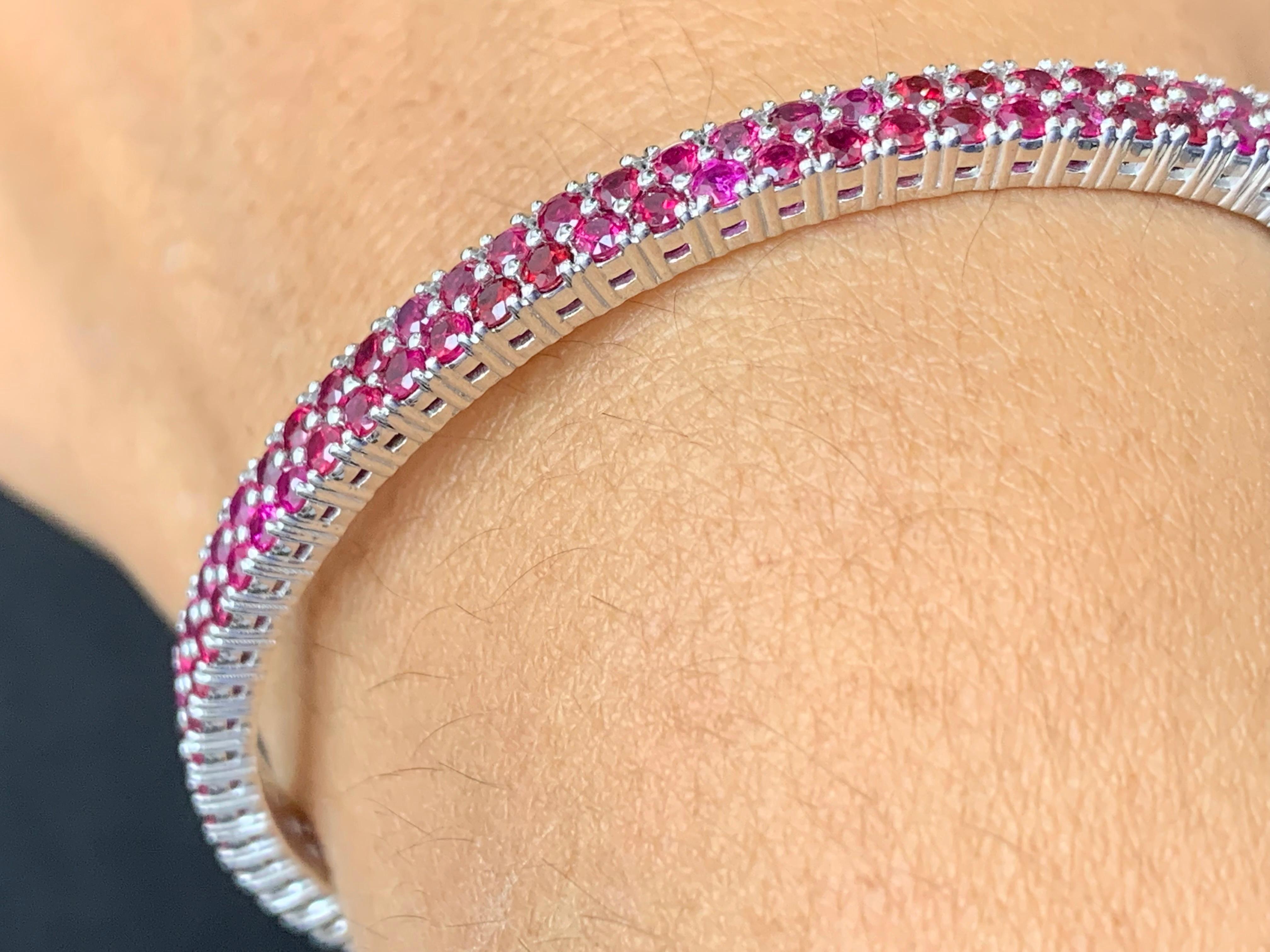A simple but elegant 2-row bangle with 75 round cut Rubies weighing 3.53 carats total. Has a clasp to slip and wear the bangle securely. Made in 14k white gold.

Style available in different price ranges. Prices are based on your selection of the
