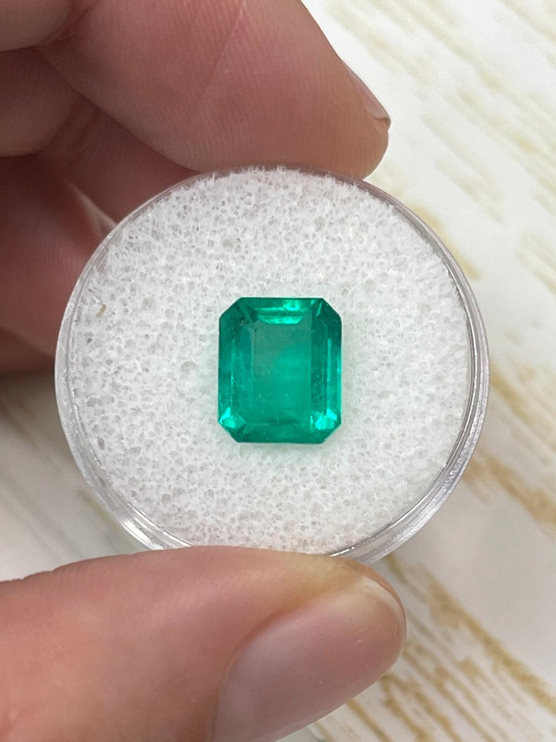 Stone: Emerald
Weight: 3.53-carats
Shape: Emerald Cut
Clarity: Transparent
Luster: Very Good
Color: Medium Bluish Green
Measurements: 9.81mm x 8.35mm x 5.67mm
Geographic Origin: Colombia
Treatment: Natural, Oiling

Comments: Due to their growth