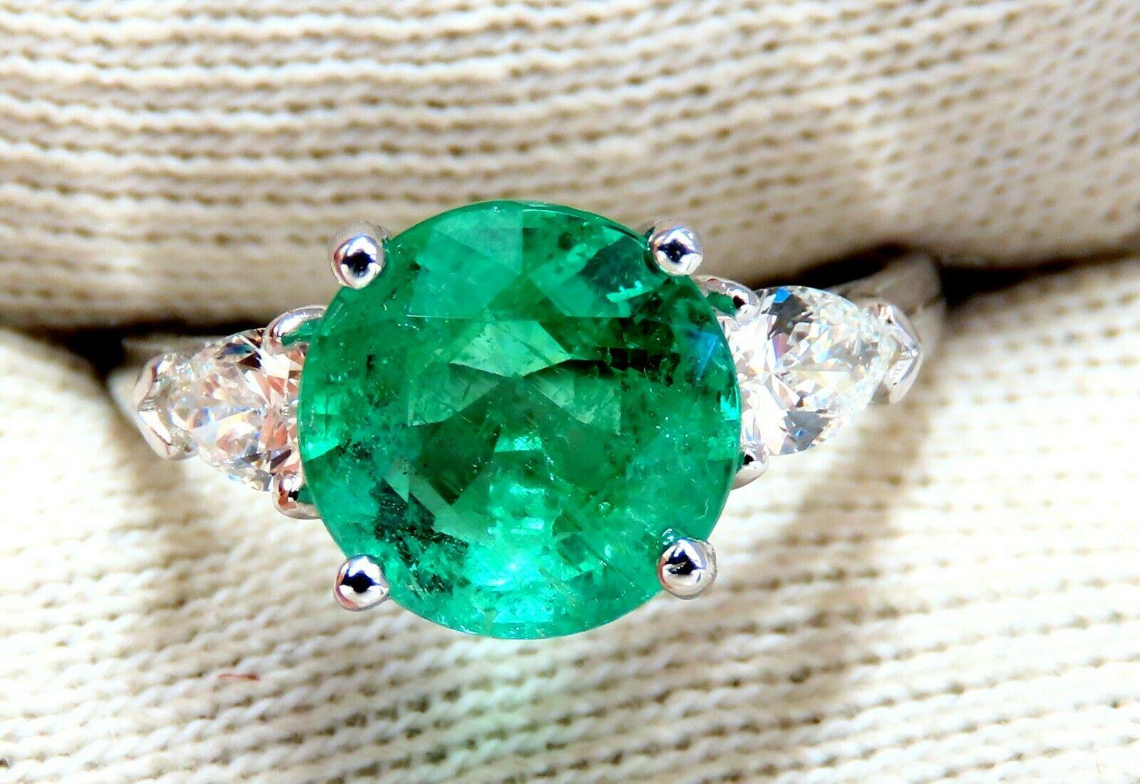 Prime Three Stone Mint Green.

3.03ct. Natural Emerald Ring

Emerald, Round Brilliant cut

9mm Diameter

Transparent & Vivid Green 

.50ct. Diamonds.

Pears & full cuts 

G-color Vs-2 clarity.  

14kt. white gold

3.2 grams

Ring Current size: