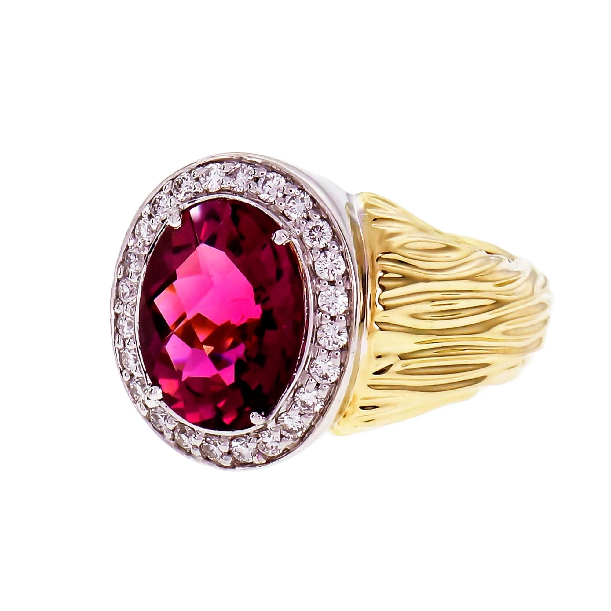 Pink Tourmaline and Diamond Cocktail Ring. 18k yellow and white gold oval Tourmaline faceted with a halo of Diamonds. The hallmark is no longer visible, only and S can be seen. 

18k 2-tone gold
1 oval pink Tourmaline, approx. total weight 3.54cts,