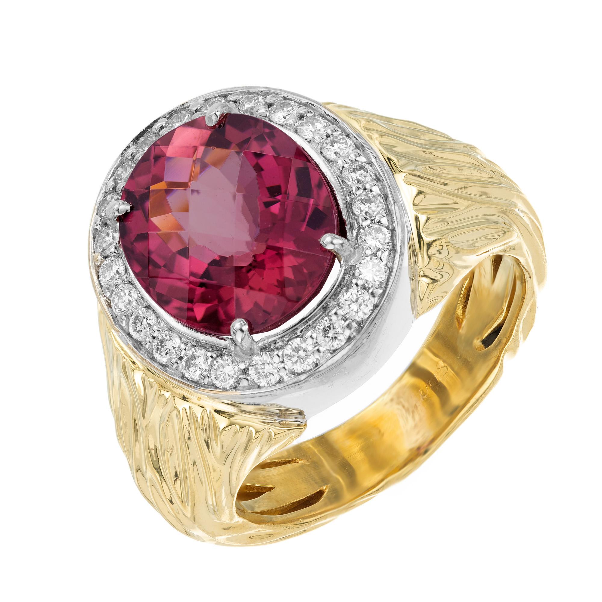 Fascinating 3.54 carat oval faceted pink tourmaline cocktail ring in 18k yellow and white gold with a diamond halo of 24 round full cut stones. This beautiful ring is of unknown origins, but crafted by a very skilled artisan. The full hallmark is no