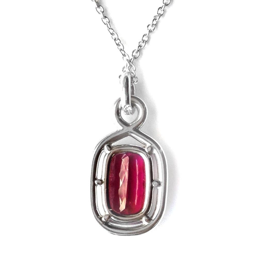 Embrace the enchantment of this Rubellite embraced by a halo of diamonds, destined to illuminate her neckline. Radiating a vibrant fuchsia pink hue, this 3.54-carat gem comes alive, embraced by pavé-set diamonds in white gold, adding a mesmerizing