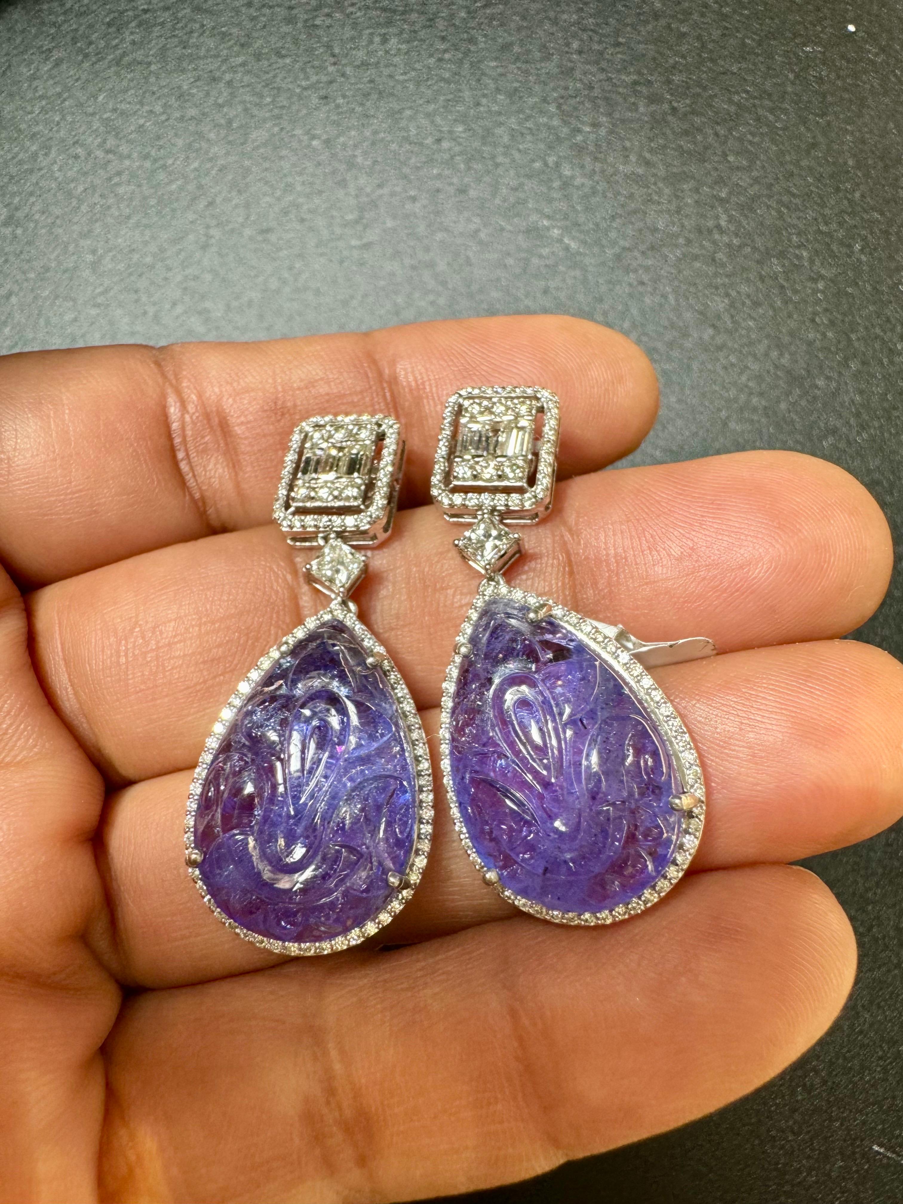 35.1.40 Ct Carved Tanzanite & 2 Ct Diamond Hanging/Cocktail Drop Earring 18 Karat White Gold
perfect pair made in  18 Carat White gold . 
18 K gold : 15 Grams
 Diamonds: approximate 2 carats
Tanzanite:  35.40 Carats
2 solitaire diamonds each 0.42 Ct