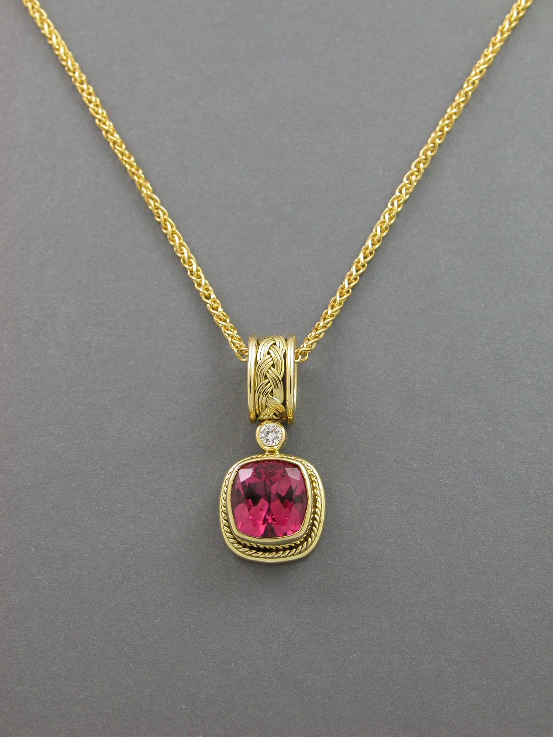 Adorn yourself with this exquisite pink tourmaline and 18k pendant accented with a brilliant white diamond hand fabricated by Lynn Kathyrn Miller, owner of Lynn K Designs. 
Faceted to perfection, the 3.54 carat cushion cut deeply saturated pink