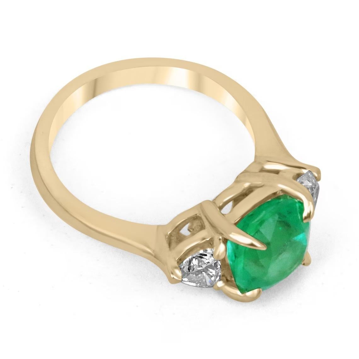 A majestic emerald and diamond three-stone right-hand/engagement ring. The center stone showcases a remarkable, natural cushion-cut fine quality ethically sourced Colombian emerald of high quality. The gemstone displays an enthralling, vivacious,