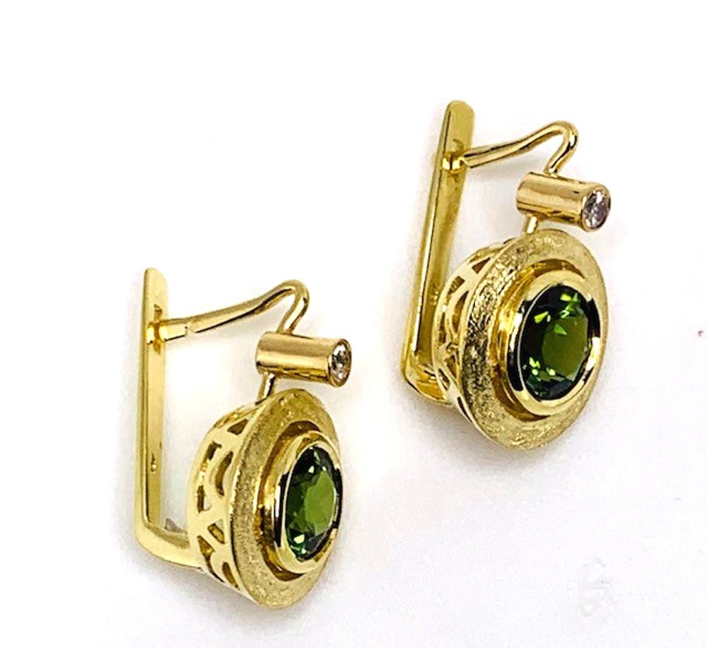  Vivid, grass-green tourmalines are set in our signature settings of  18k yellow gold. The tourmalines are a large, 7.50mm diameter, set in handmade bezels framed by a textured brush finish and topped off with a sparkling diamond! These chic