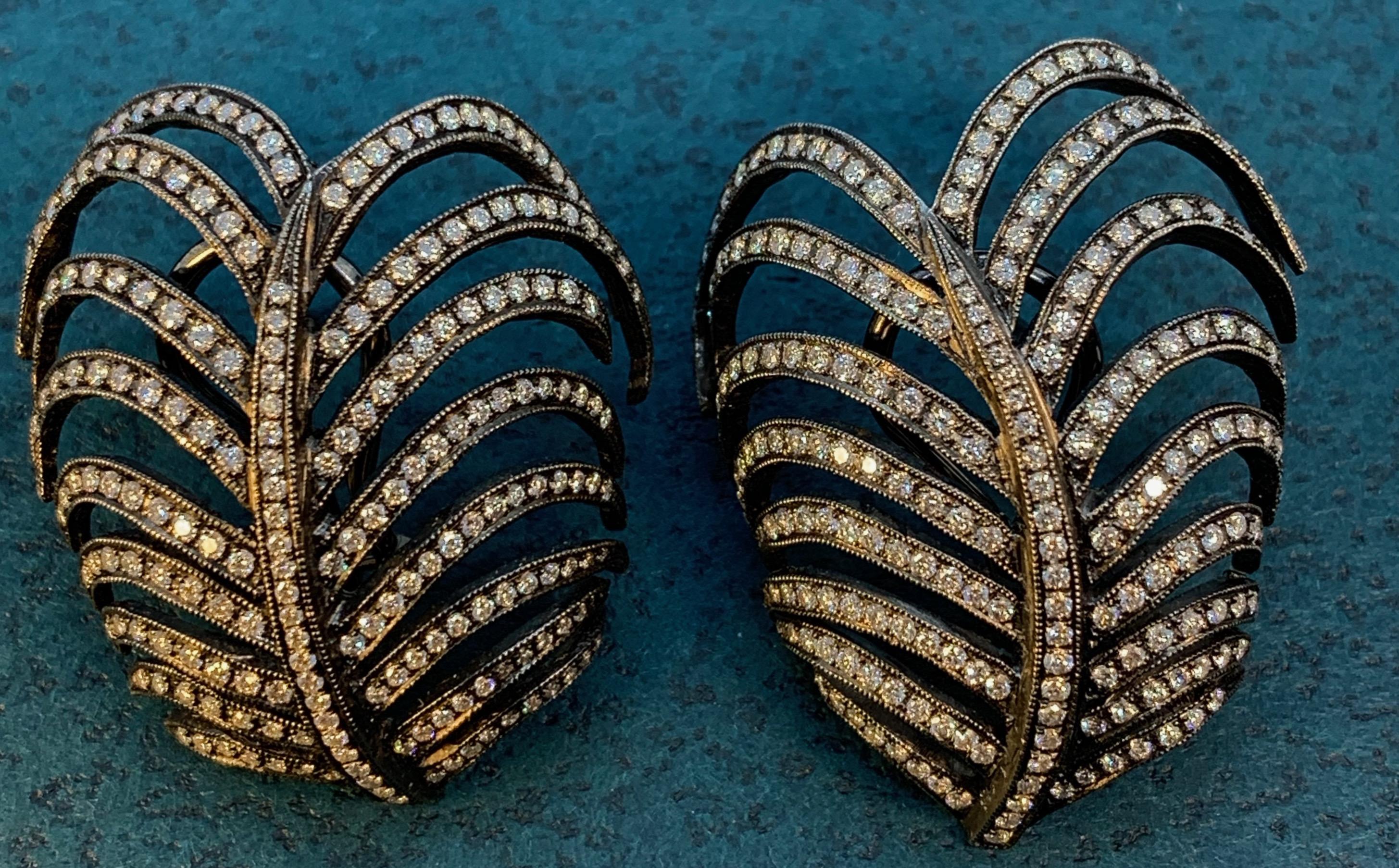 These meticulously hand-set, one-of-a-kind earrings are based on the graceful fronds of Australia's kentia palms.  The designer, Eytan Brandes, made a conscious decision to cast the earrings in two molds so that, instead of mirror images, they're