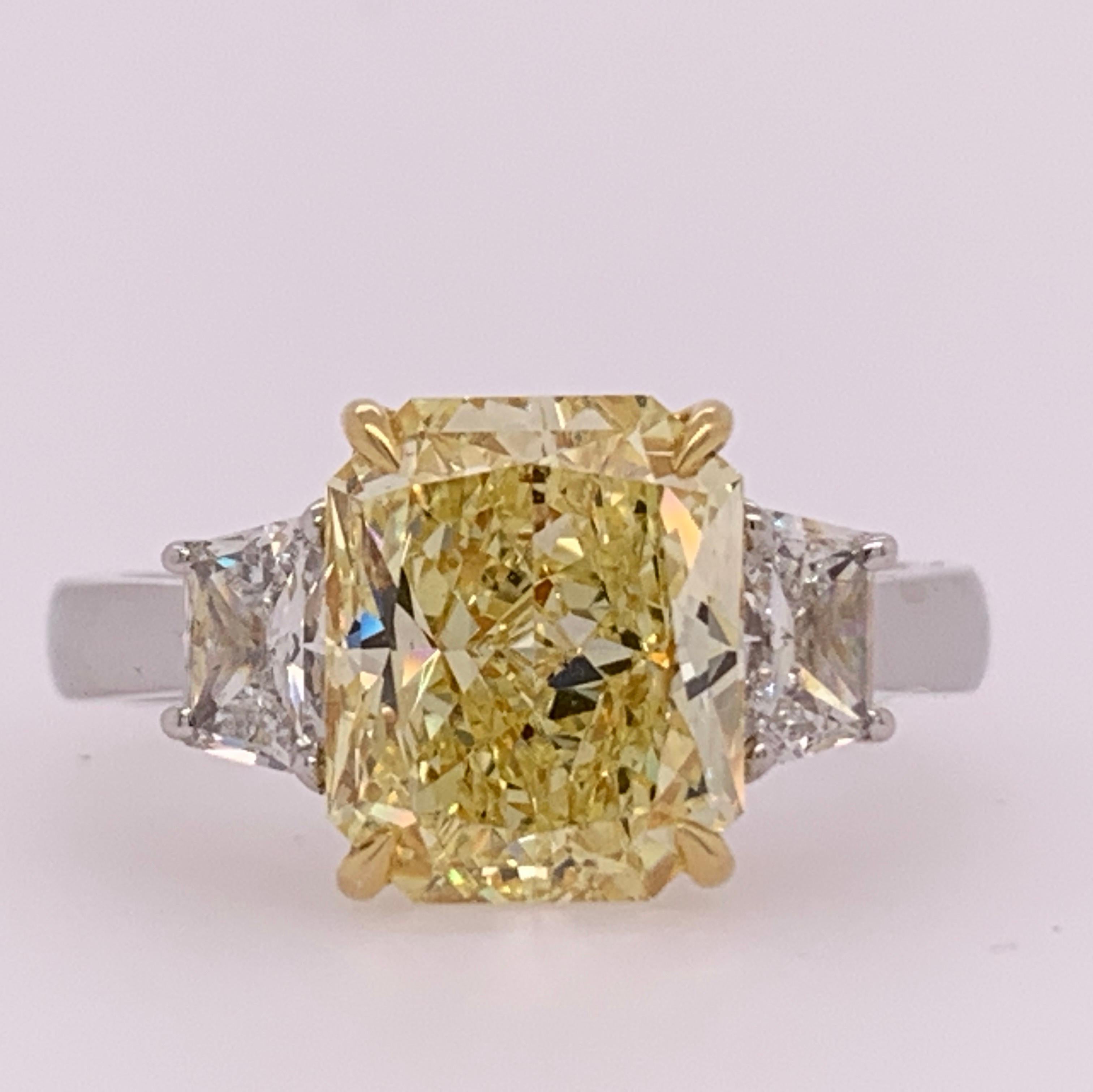 A stunning GIA certified Fancy Yellow radiant cut that looks like a much larger stone for its weight (size 6.25). The color saturation is very strong, a borderline intense.....

The inclusions (si1) are pleasant and the sidestones are colorless (F