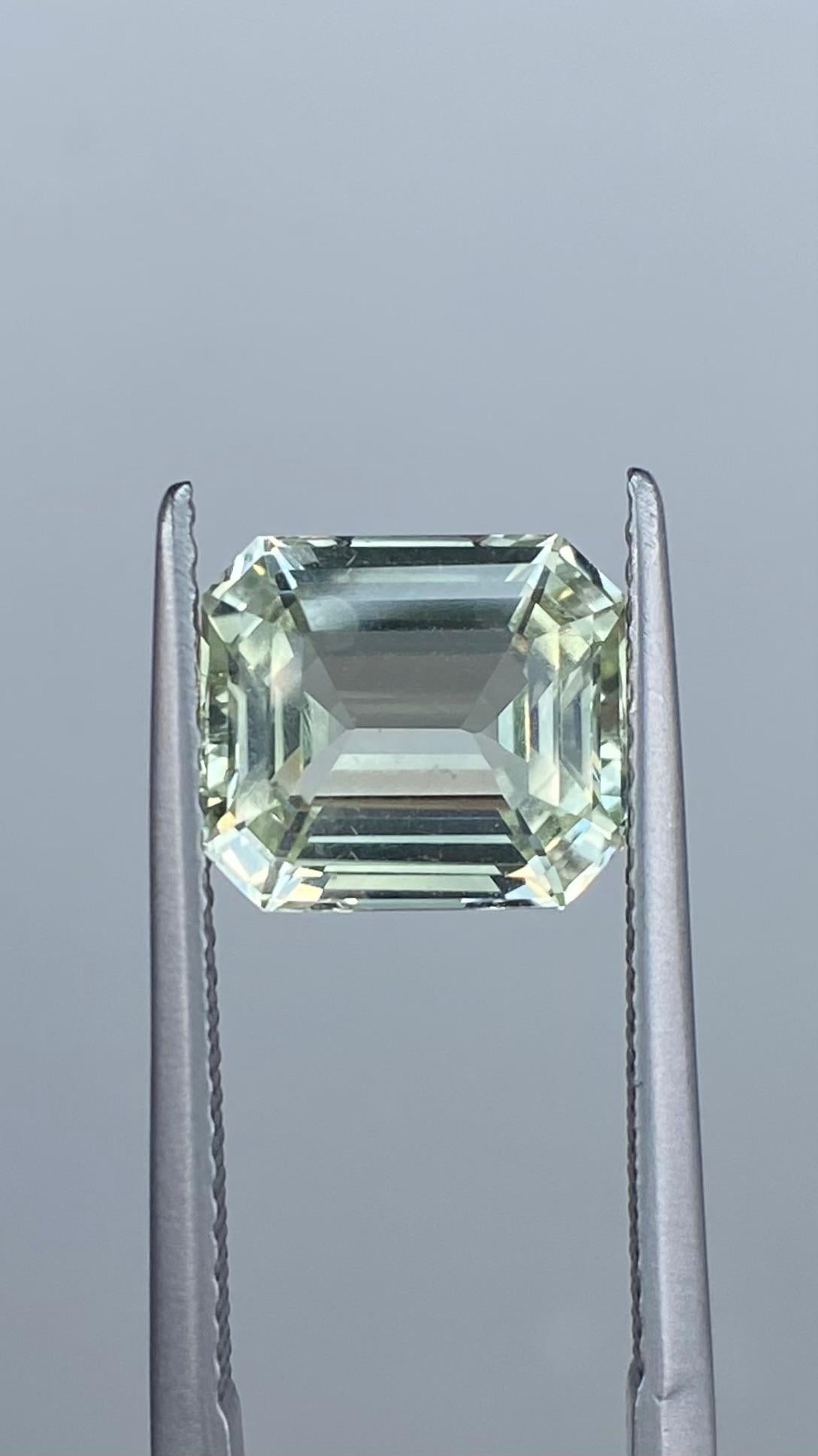 The Sapphire Merchant proudly presents this enchanting natural beauty, a Mint Pastel Green Sapphire, sourced from the gem-rich lands of Sri Lanka (Ceylon). Weighing in at 3.55 carats, its clean emerald cut showcases its subtle green hue and