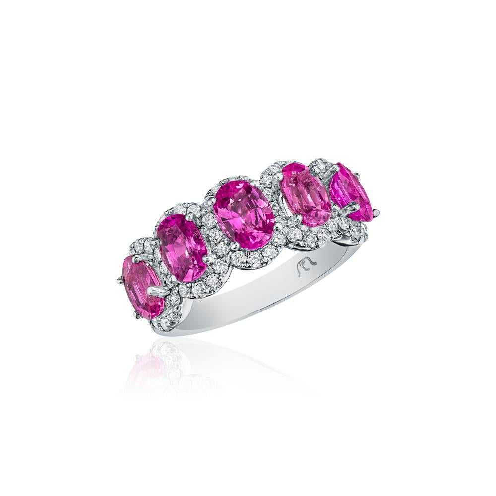 • Crafted in 14KT gold, this band is made with 5 oval cut pink sapphires which are framed by a delicate halo comprised of round brilliant cut diamonds. The band has a combining total weight of approximately 3.55 carats.

Worn beautifully on its own,
