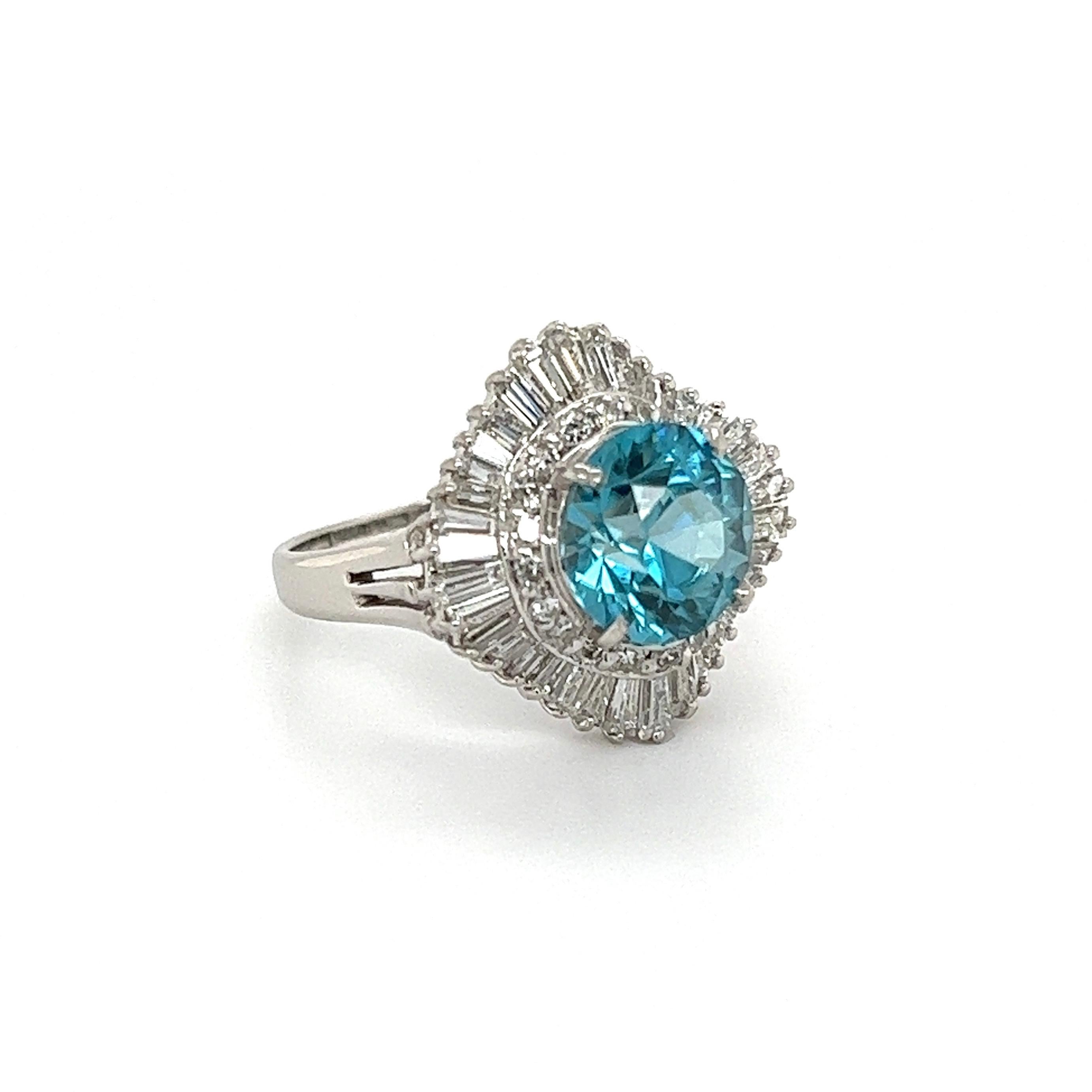 Simply Beautiful! Finely detailed Blue Zircon and Diamond Ballerina Ring. Centering a securely nestled Hand set awesome 3.56 Carat Blue Zircon, surrounded by Diamonds, weighing approx. 1.18tcw. Hand crafted Platinum mounting. Approx. dimensions: