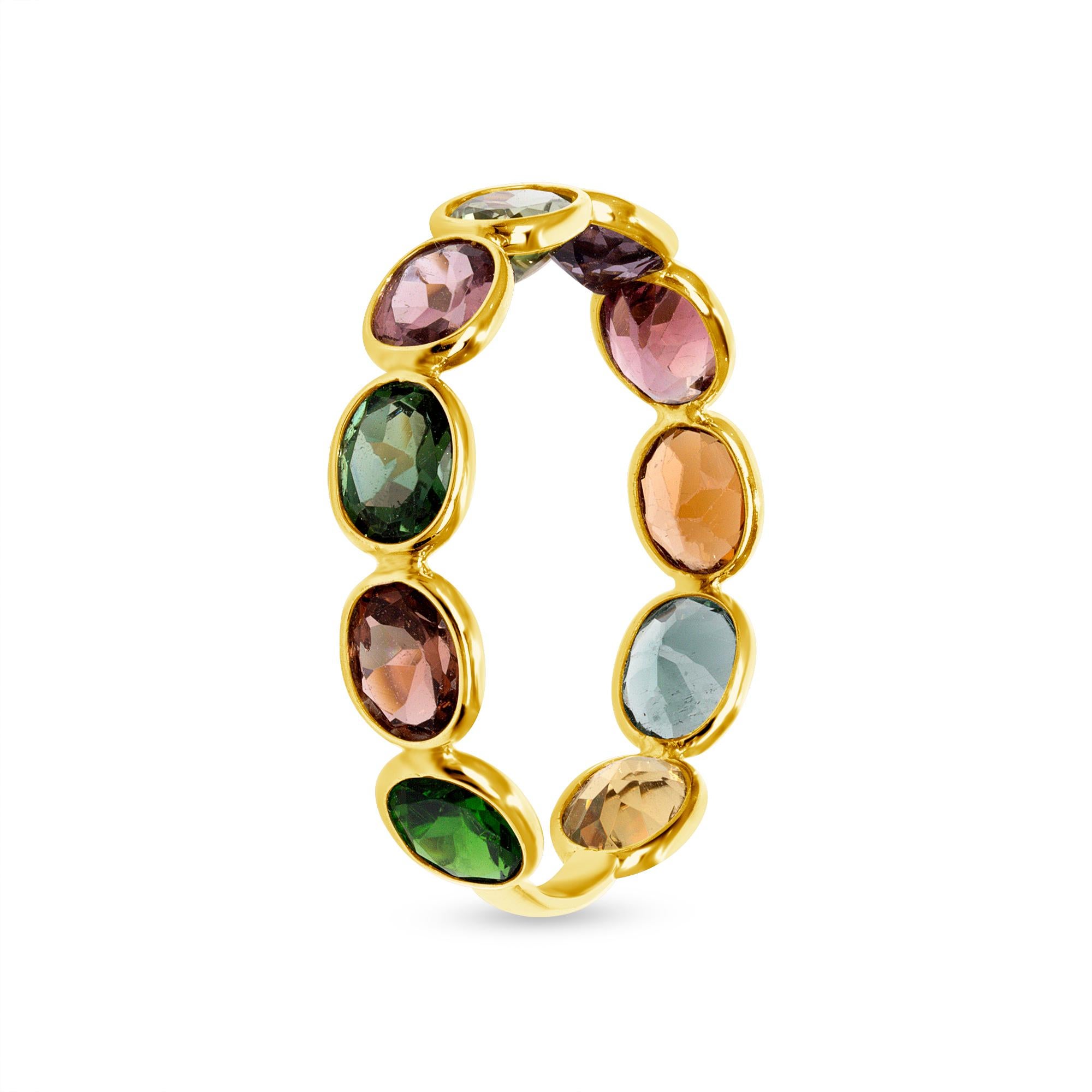 Designed by award-winning artist Brenda Smith, this band ring is made with faceted natural multicolor sapphires with a carat total weight of 3.56 and 18-karat yellow gold. It is in stock and available in sizes 5 through 7. This ring is colorful but