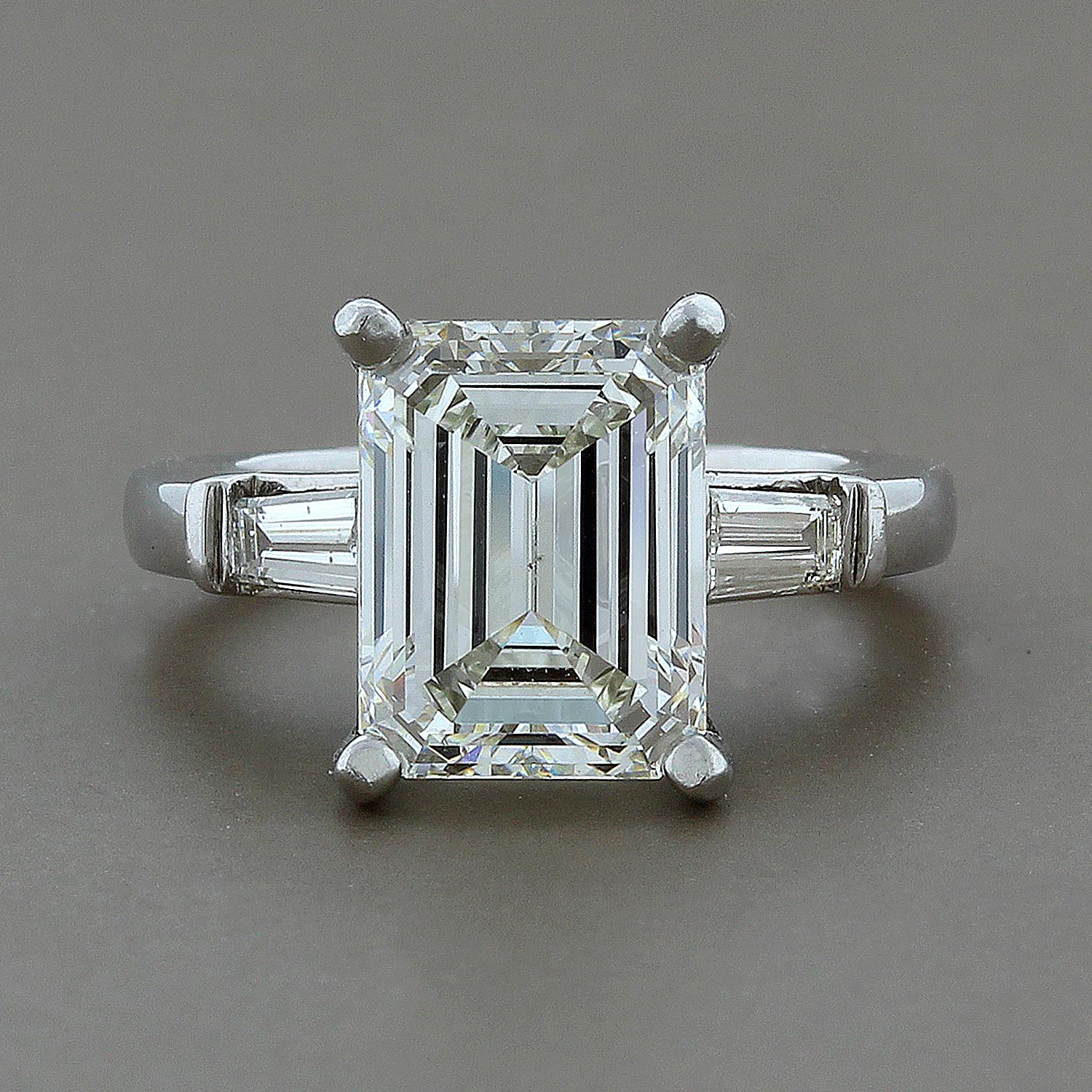 A beautiful 3.57 carat emerald cut diamond traditionally set with two tapered side diamond baguettes, totaling 0.25 carats.  The emerald cut diamond is GIA certified showing J color and VS2 clarity.  The polish and symmetry are both stated as