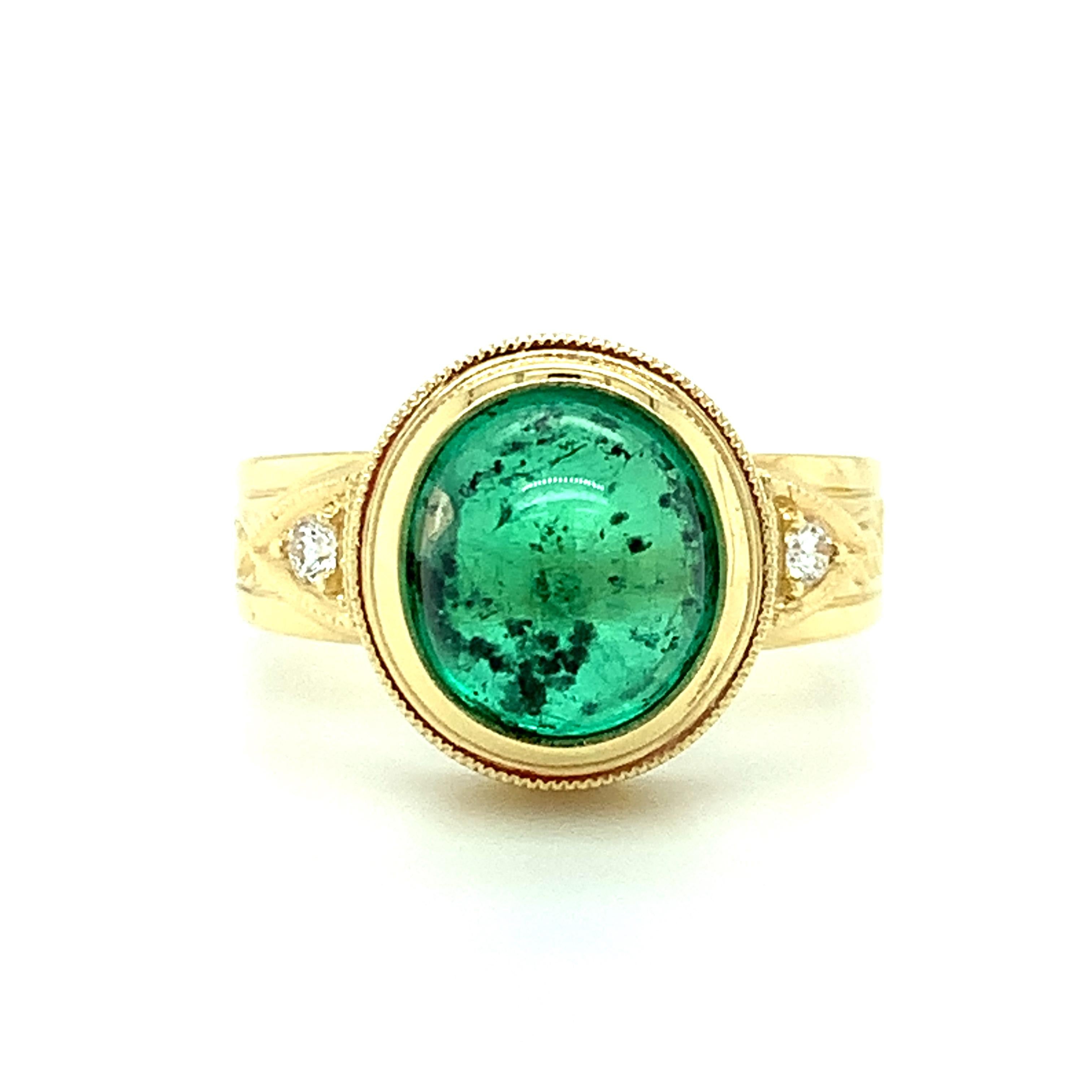 This beautiful 18k yellow gold handmade ring is set with a vibrant green 3.57 carat emerald cabochon and round brilliant cut diamonds in one of our signature designs. The ring was custom made for this emerald, using old-world techniques and a level