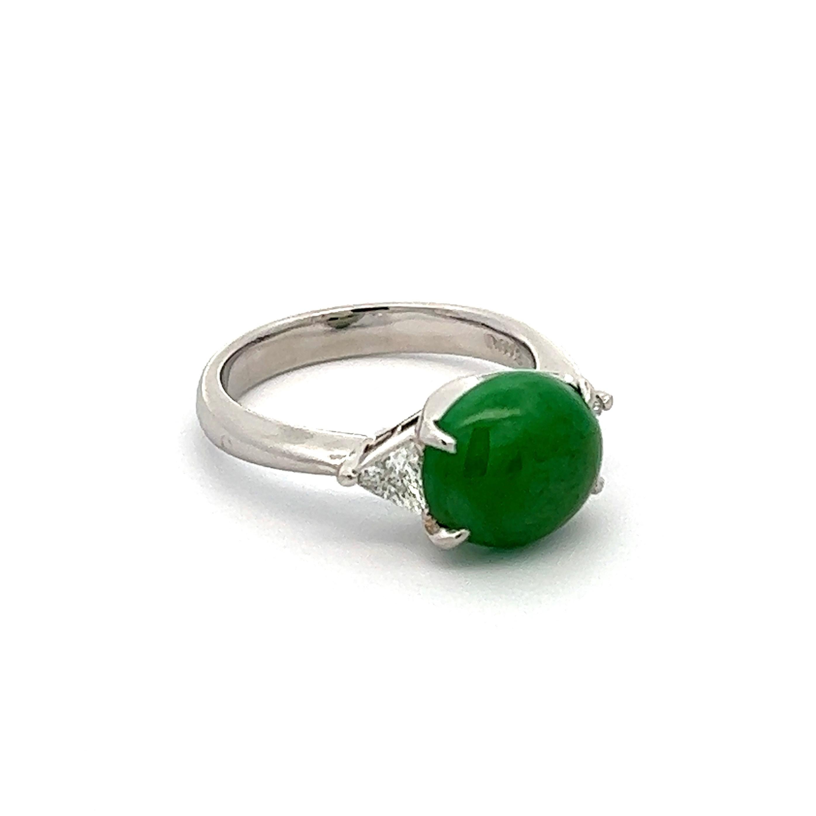 Simply Beautiful! Three Stone Platinum Ring, centering a securely nestled Grade A Jadeite Jade weighing approx. 3.57 Carat, GIA # 2221572897, either side enhanced by Diamonds, weighing approx. 0.22tcw. Hand crafted Platinum mounting. Ring size 6, we