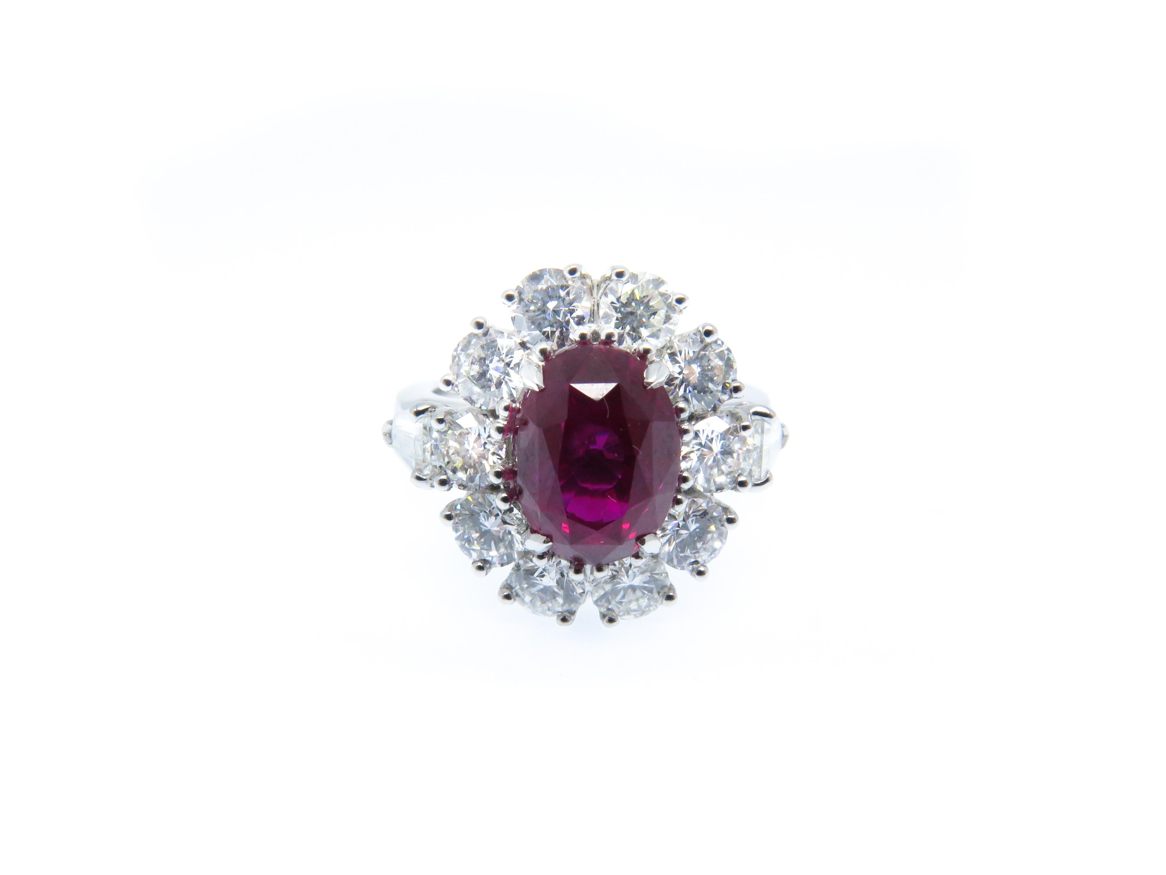 Ruby is a stone of divine creativity and symbol of good fortune, pure love, and loyalty. 

An impressive oval shape Mozambique Ruby weighing 3.57 carats centred within a brilliant cut diamond cluster weighing 1.55 carats. With tapered baguette