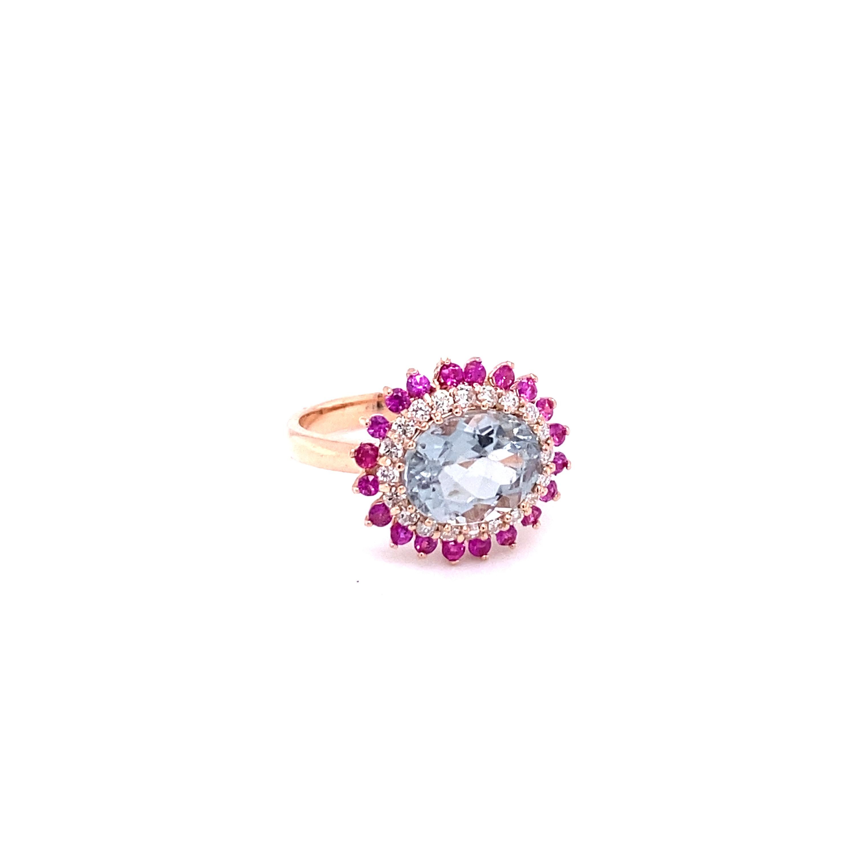 This Ring has a pretty light blue Oval Cut Tourmaline as its center stone that weighs 2.82 carats.
The Tourmaline is surrounded by 20 sparkly Round Cut Diamonds that weigh 0.32 Carats (Clarity: SI2, Color: F) and followed by a row of bright Pink