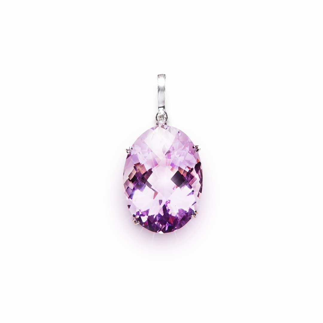 This detachable and very bright oval Amethyst with a weight of 35.79 Carat and Diamond Enhancer was handmade in a fine claw setting. The diamond weighs 0.065 Carat, Colour F/G, Clarity SI. Can be worn with a gold necklace or cable, a strand of