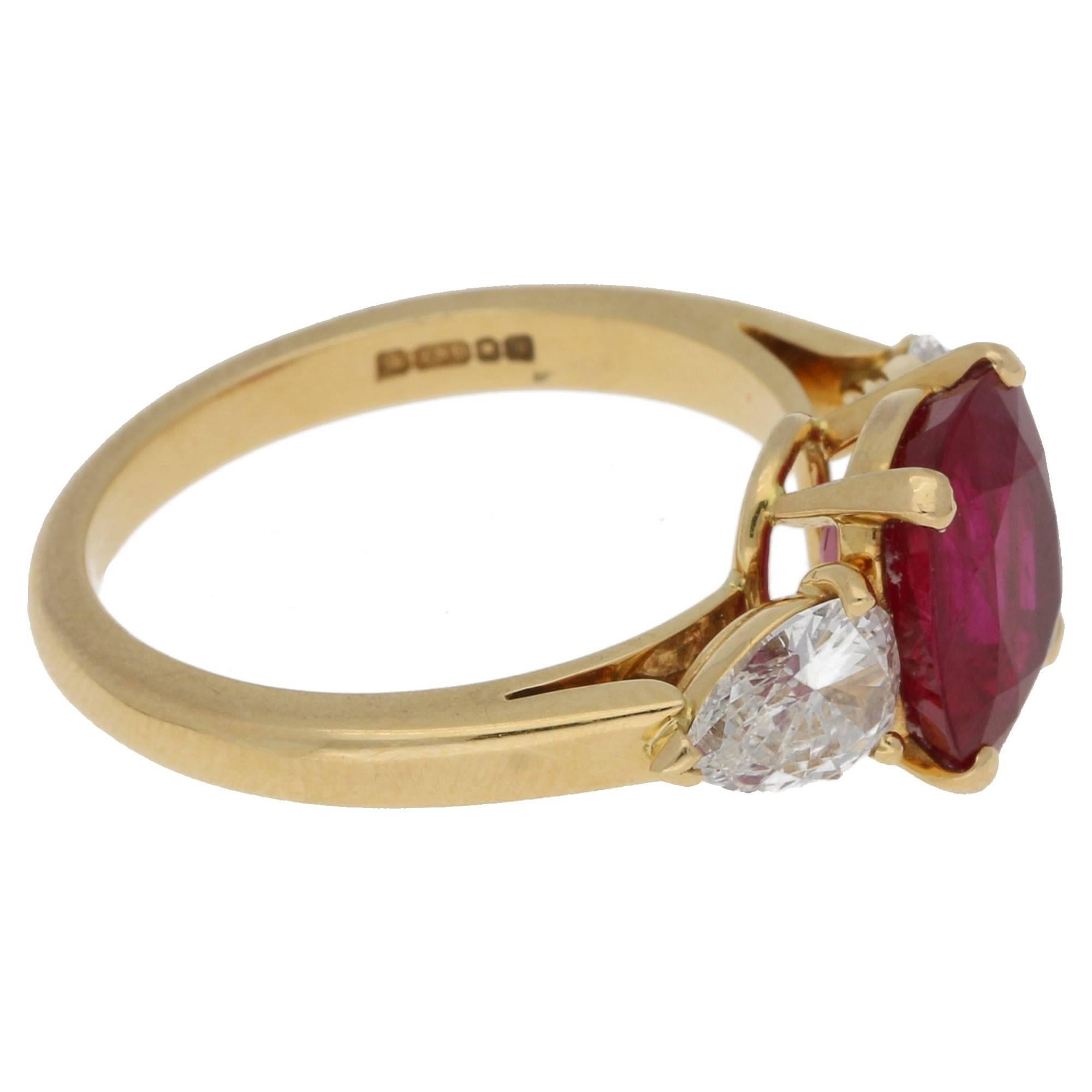 An astounding Burmese ruby and diamond engagement ring set in an 18k yellow gold. The central hand-cut cushion shaped Burmese ruby is four-claw set and accompanied by a Gubelin Certificate.  The central stone is then flanked by two impeccably
