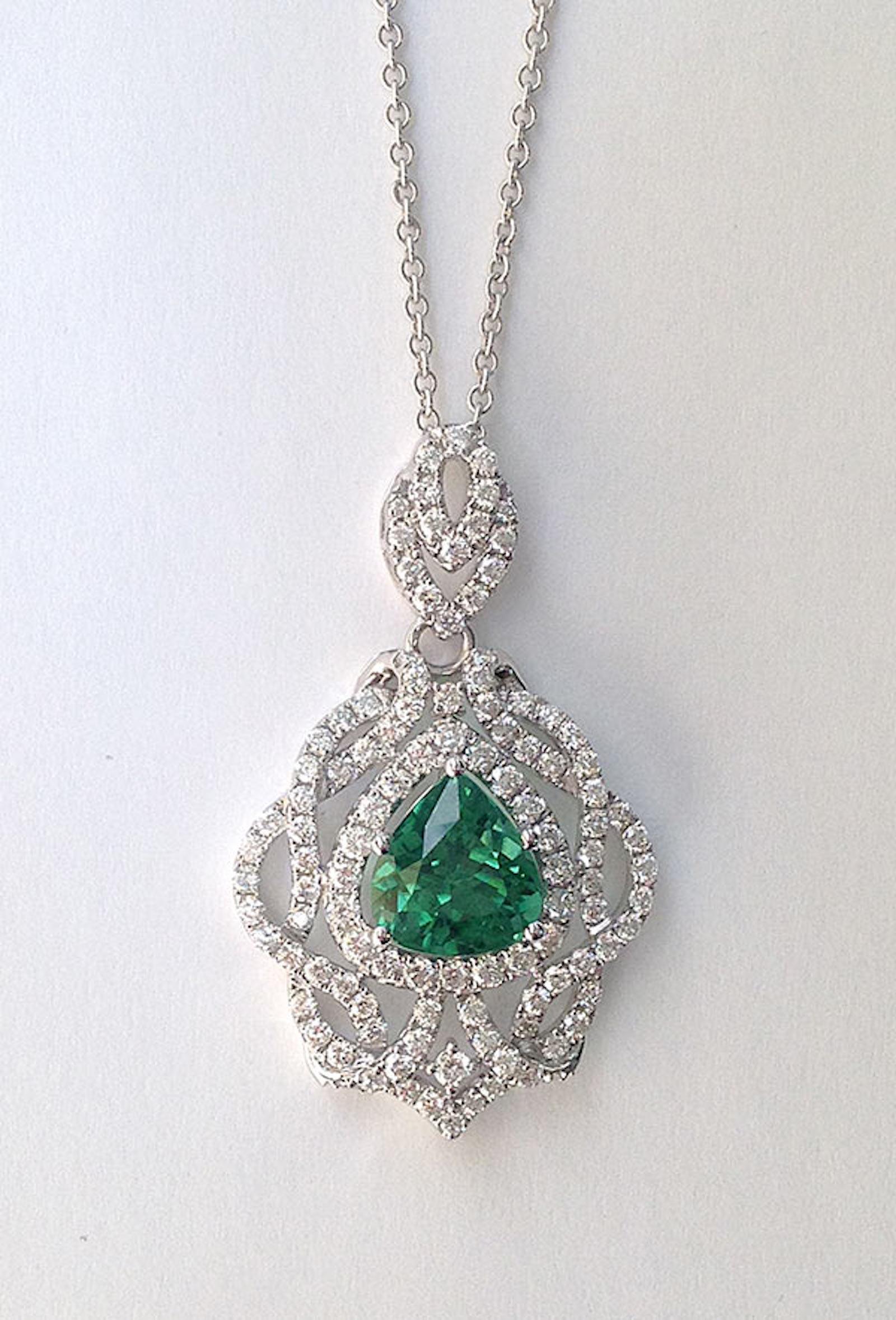 Mint Green, a hue that complements various skin tones, comes to life in this oval-shaped, mixed-cut Tourmaline. It delicately lets light in, dispersing a captivating play of color. Nestled in a 14K White Gold setting adorned with diamonds in a