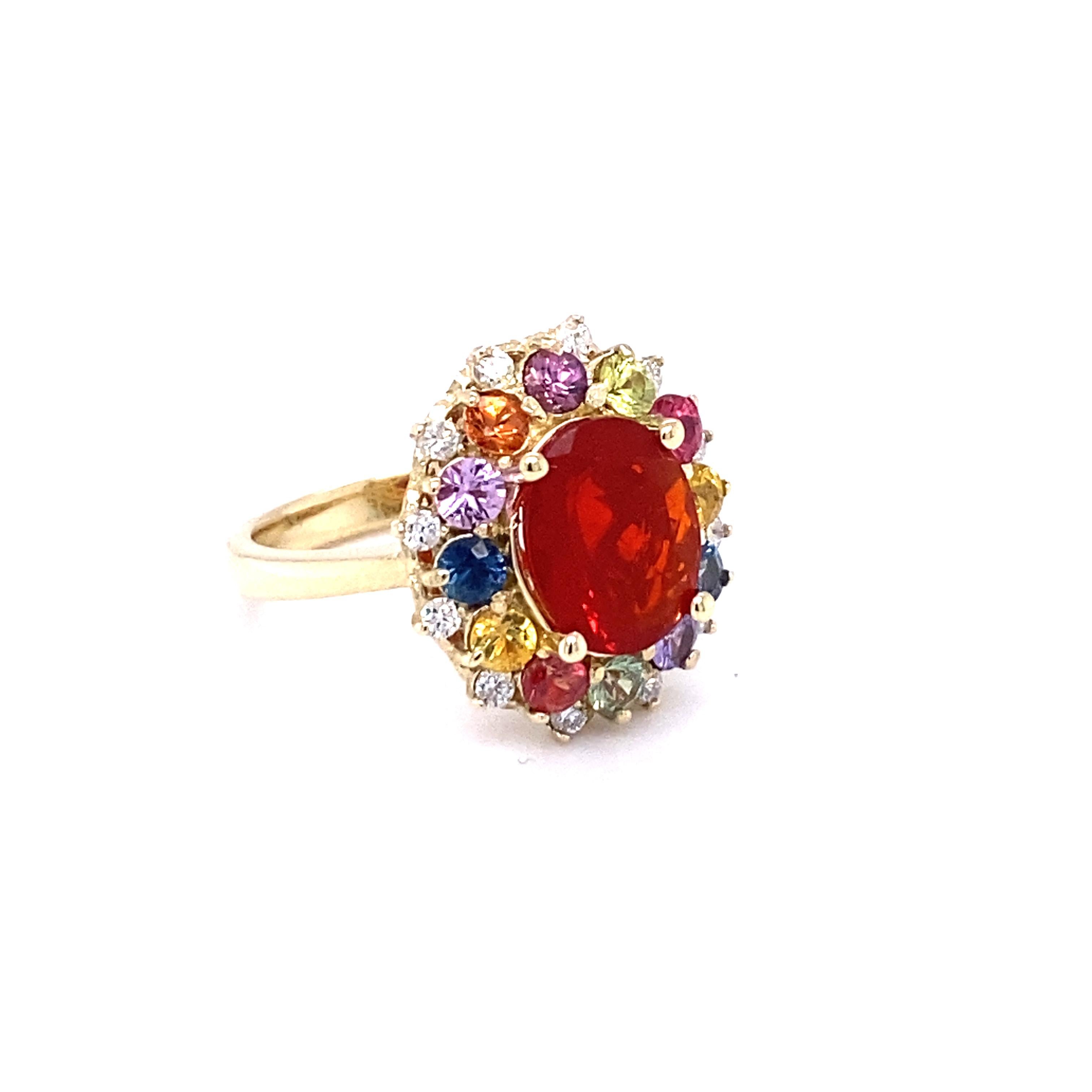 This Ring has a 2.06 carat Oval Cut Fire Opal as its center stone and is beautifully surrounded by 12 Multi-Colored Sapphires that weigh 1.52 Carats and 12 Round Cut Diamonds that weigh 0.26 carats (Clarity: SI2, Color: F)

The Total Carat Weight of