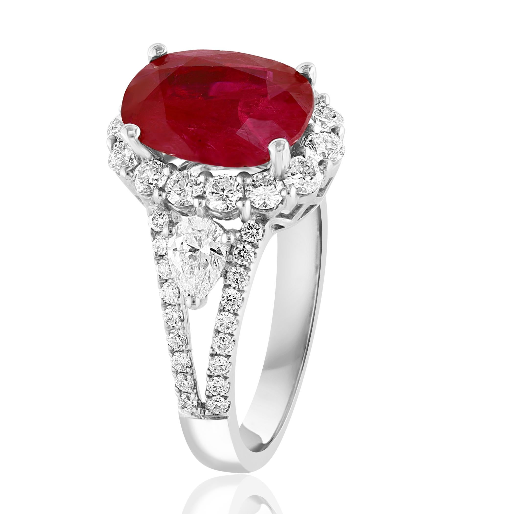 A stunning ring showcasing a rich Red Oval Cut Ruby weighing 3.58 carats surrounded by a row of diamonds. Flanking the center stone are brilliant cut 2 pear diamonds and accent diamonds, weighing 1.20 carats total, framed in a brilliant diamond