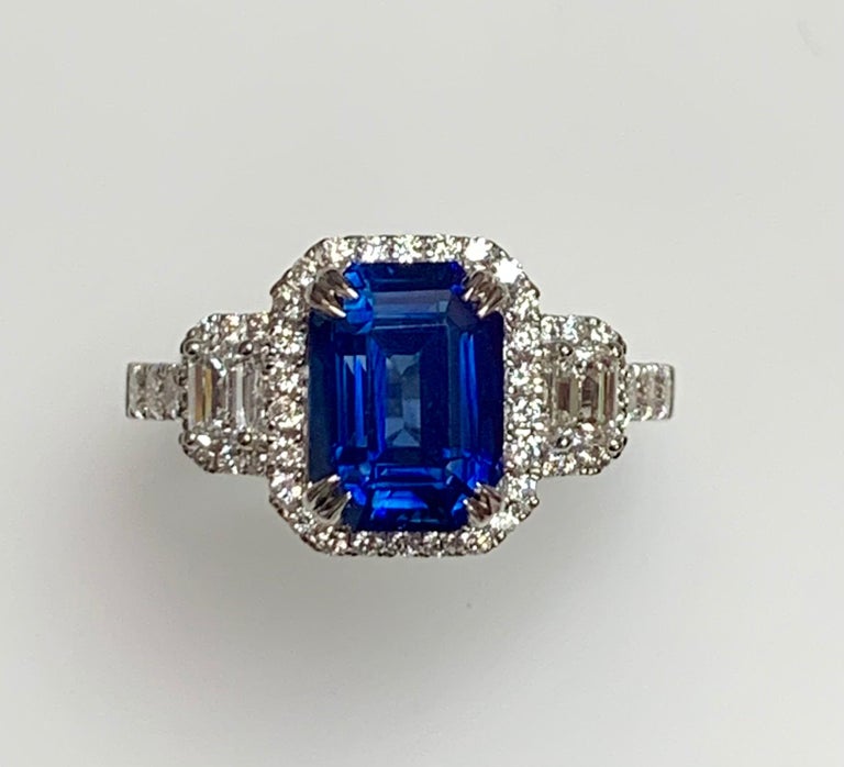 3.58 Carat Emerald cut sapphire set in 18k whit gold ring with rund diamonds around it and baguette diamonds .